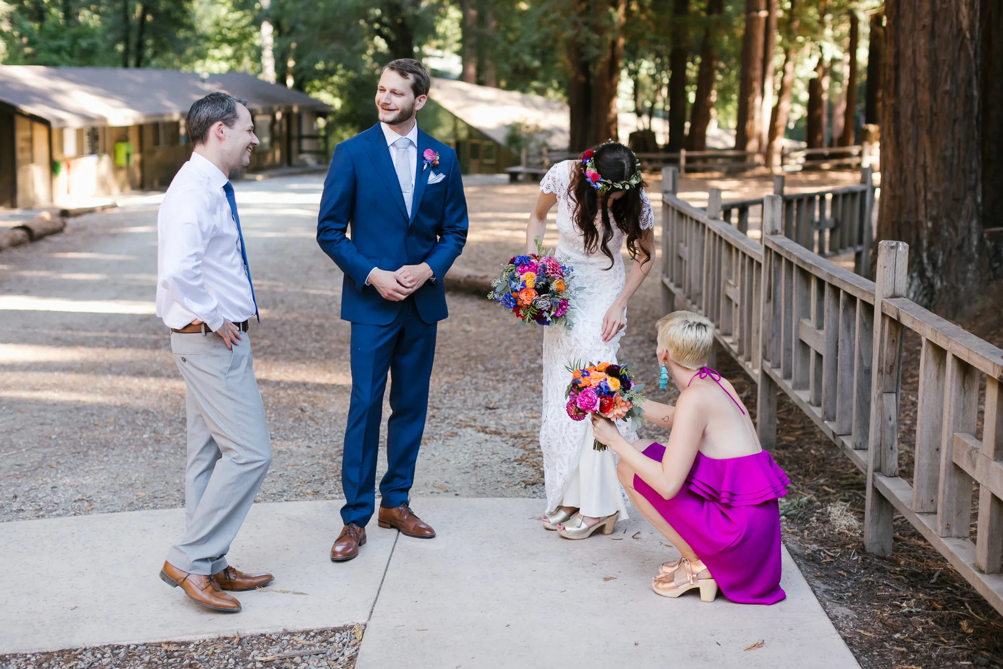 Colorful wedding couple relax with close friends after ceremony