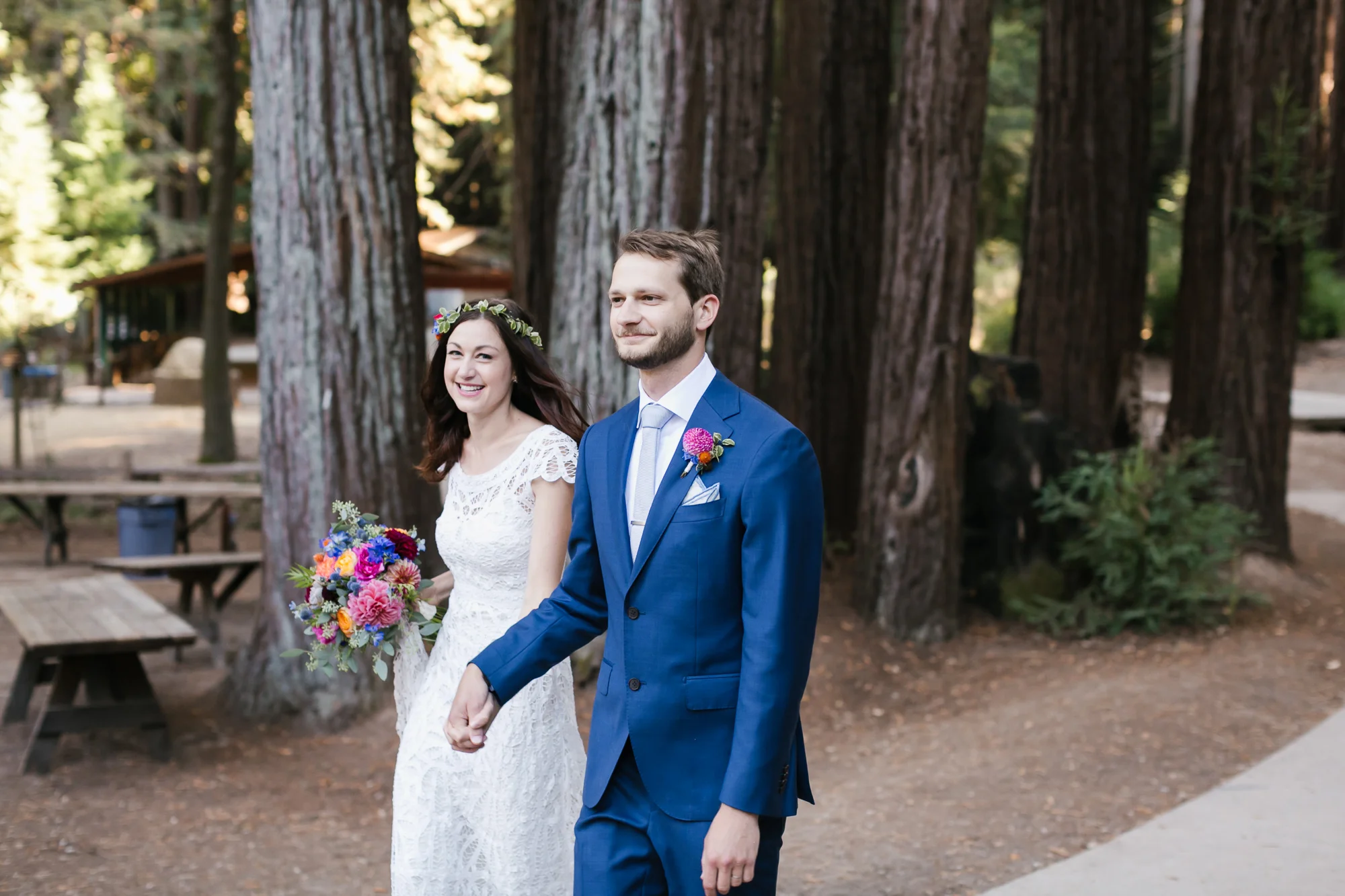 Bright wedding couple happily walk into their reception