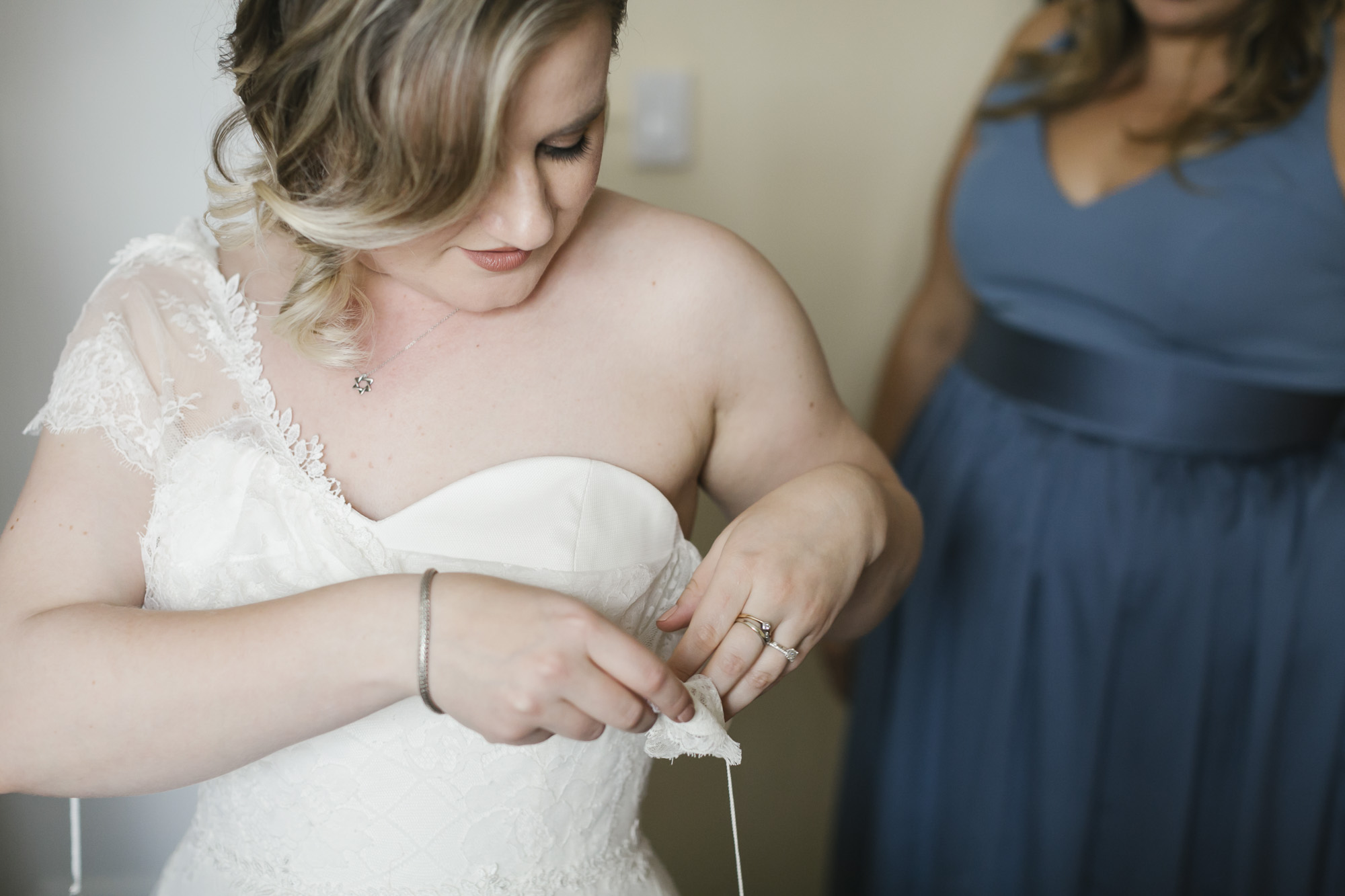 A bride gets into her wedding dress