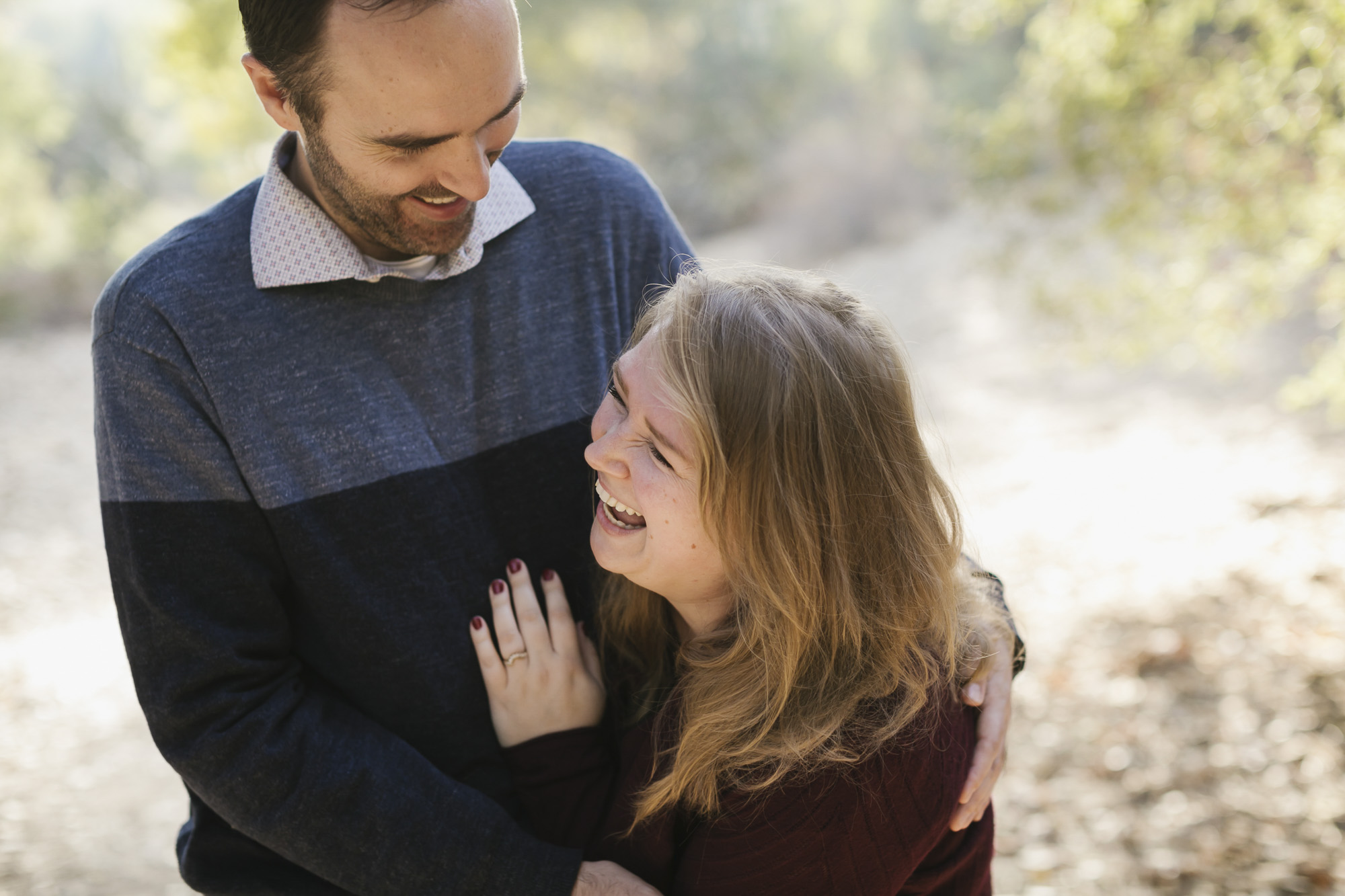 Engaged couple laugh hysterically at Arroyo Seco in Pasadena