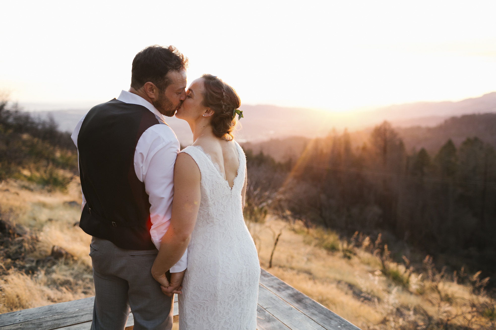 Wedding couple kiss at sunset in front of Sonoma wildfire damage