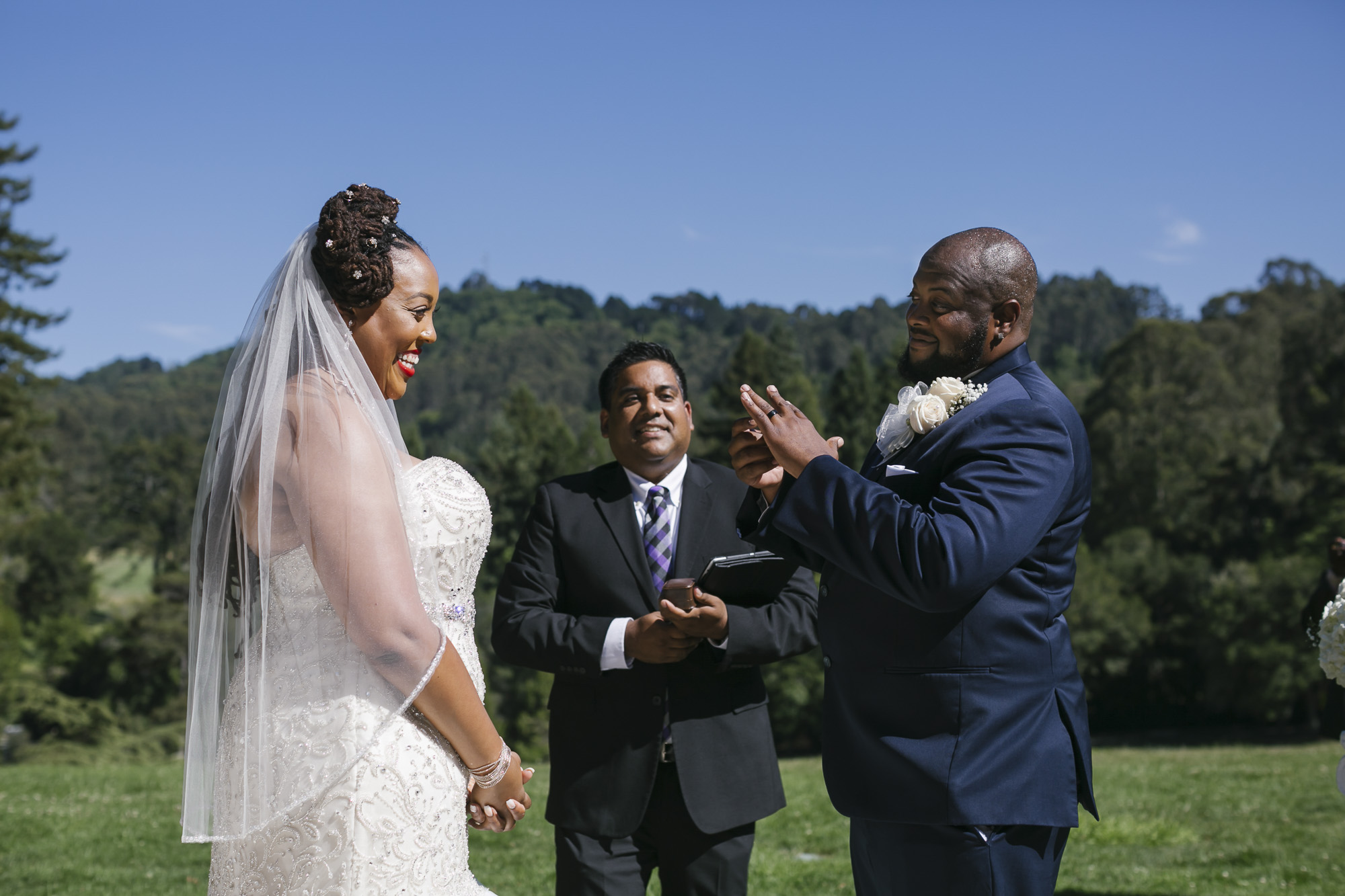 Groom admires his wedding ring at outdoor ceremony in Tilden Park