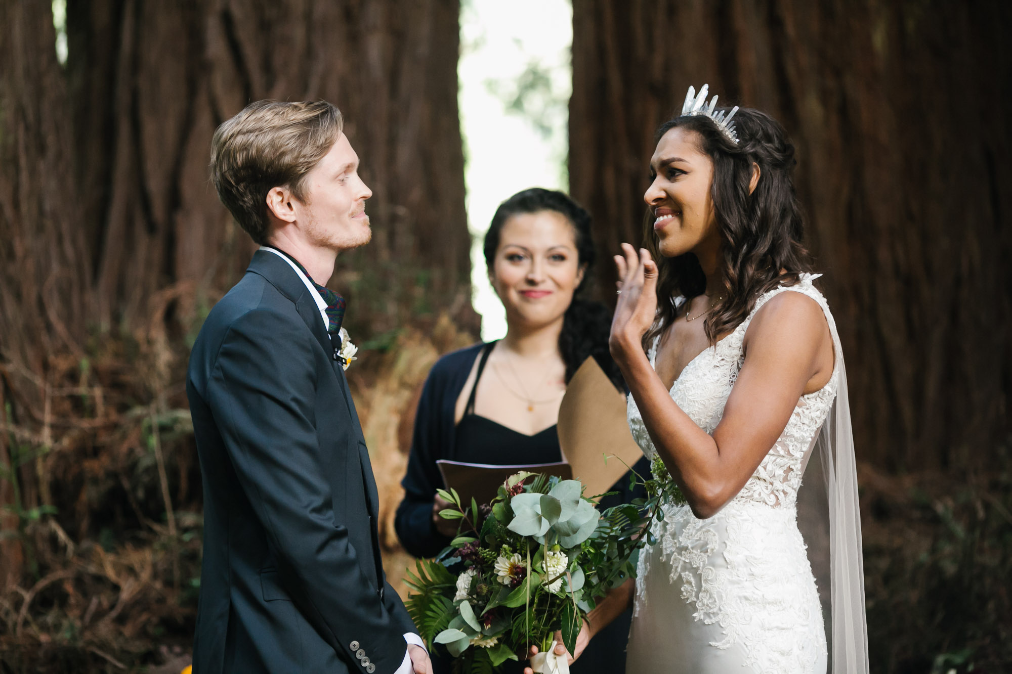 Bride gets emotional during ceremony in redwood grove