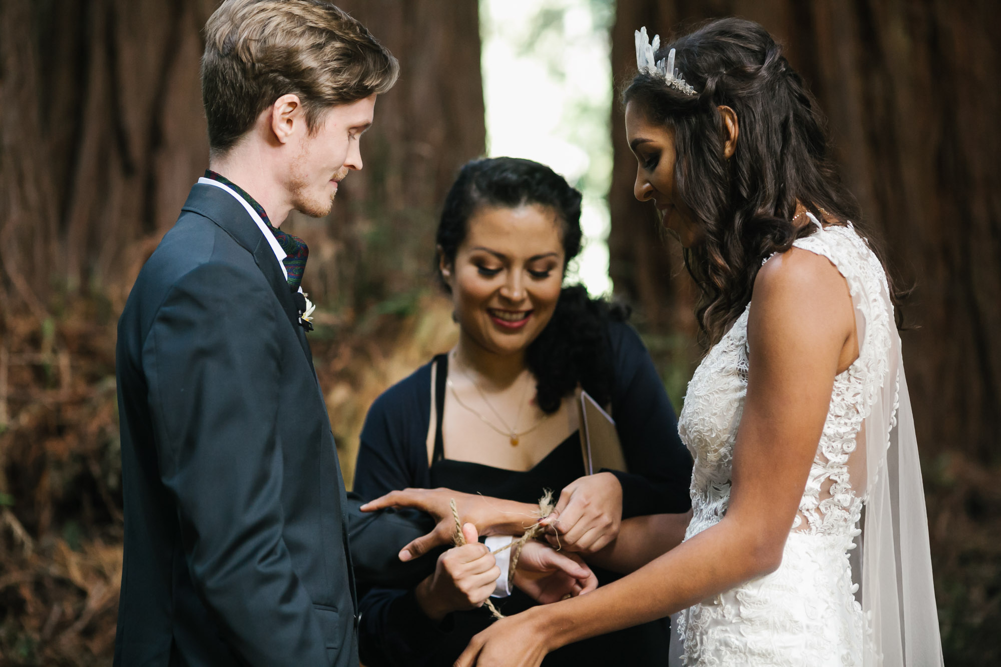 Wedding couple bind hands with rope during ceremony