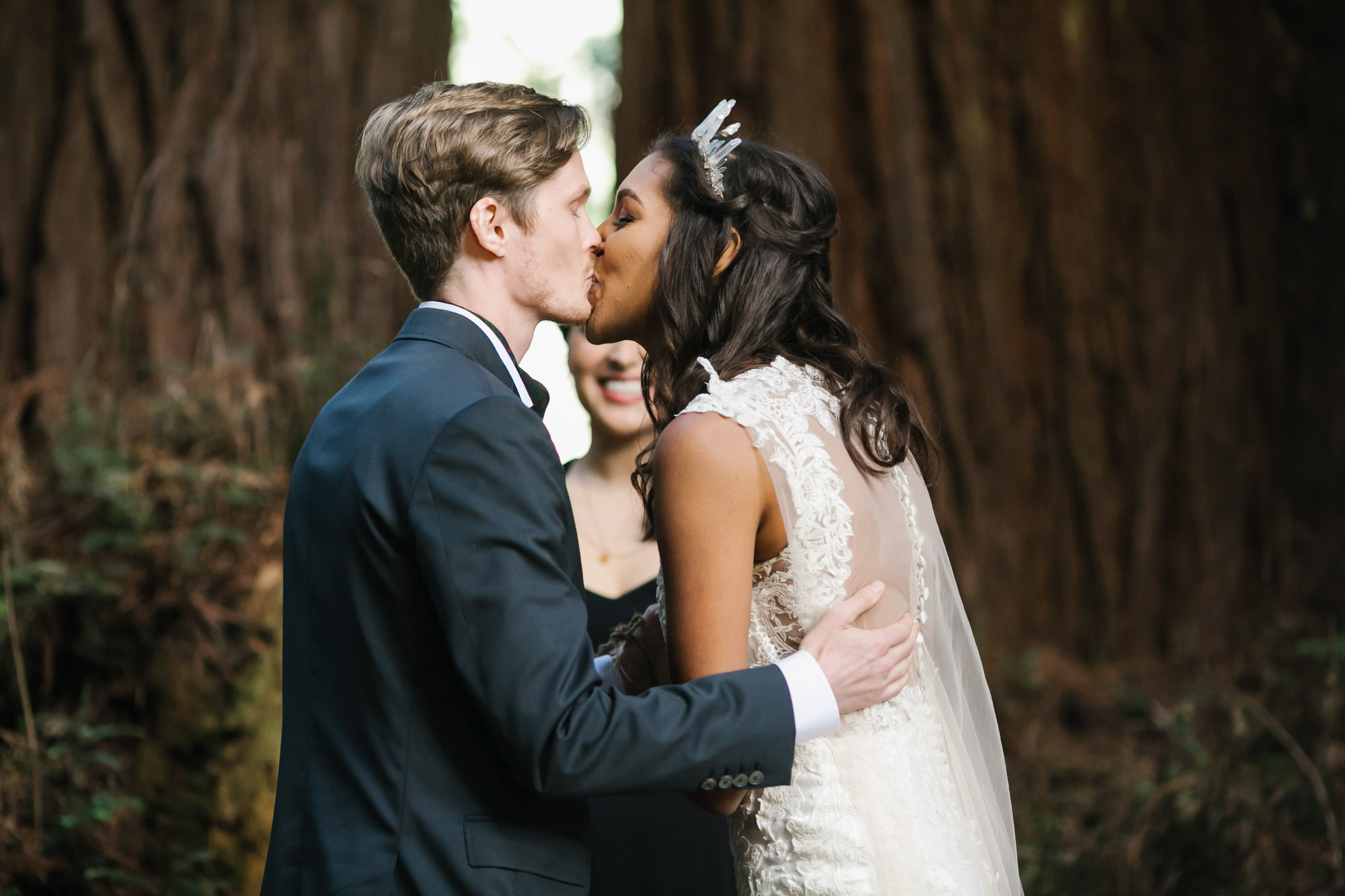 Bride and groom share their first kiss at their wedding ceremony