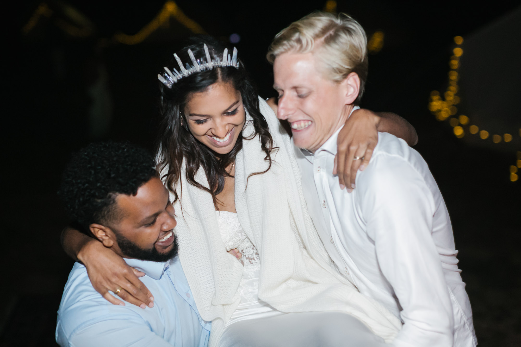 Friends lift the bride to carry her into the dance party