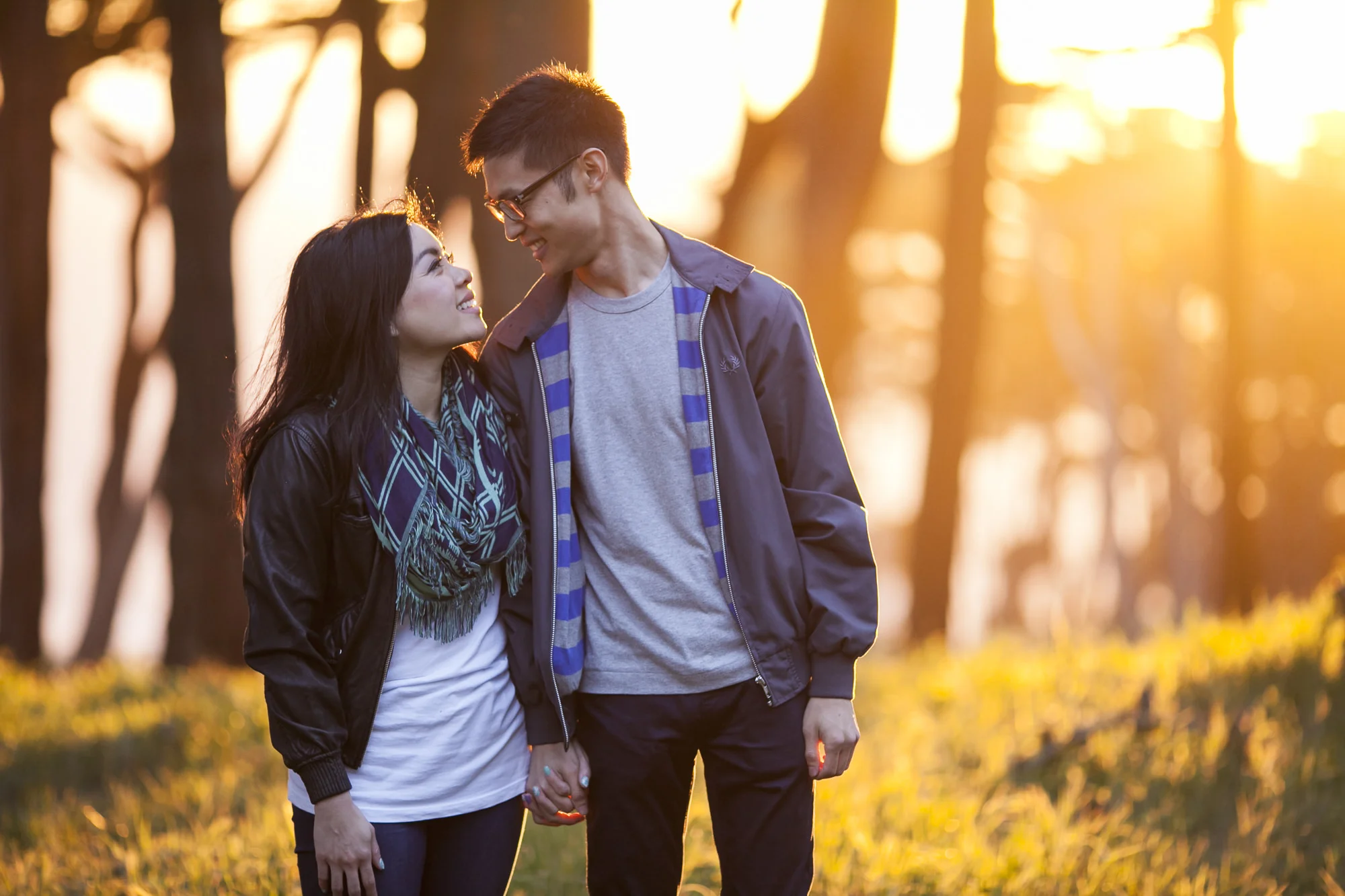 Engagement session at Lands End in San Francisco with golden sunset behind