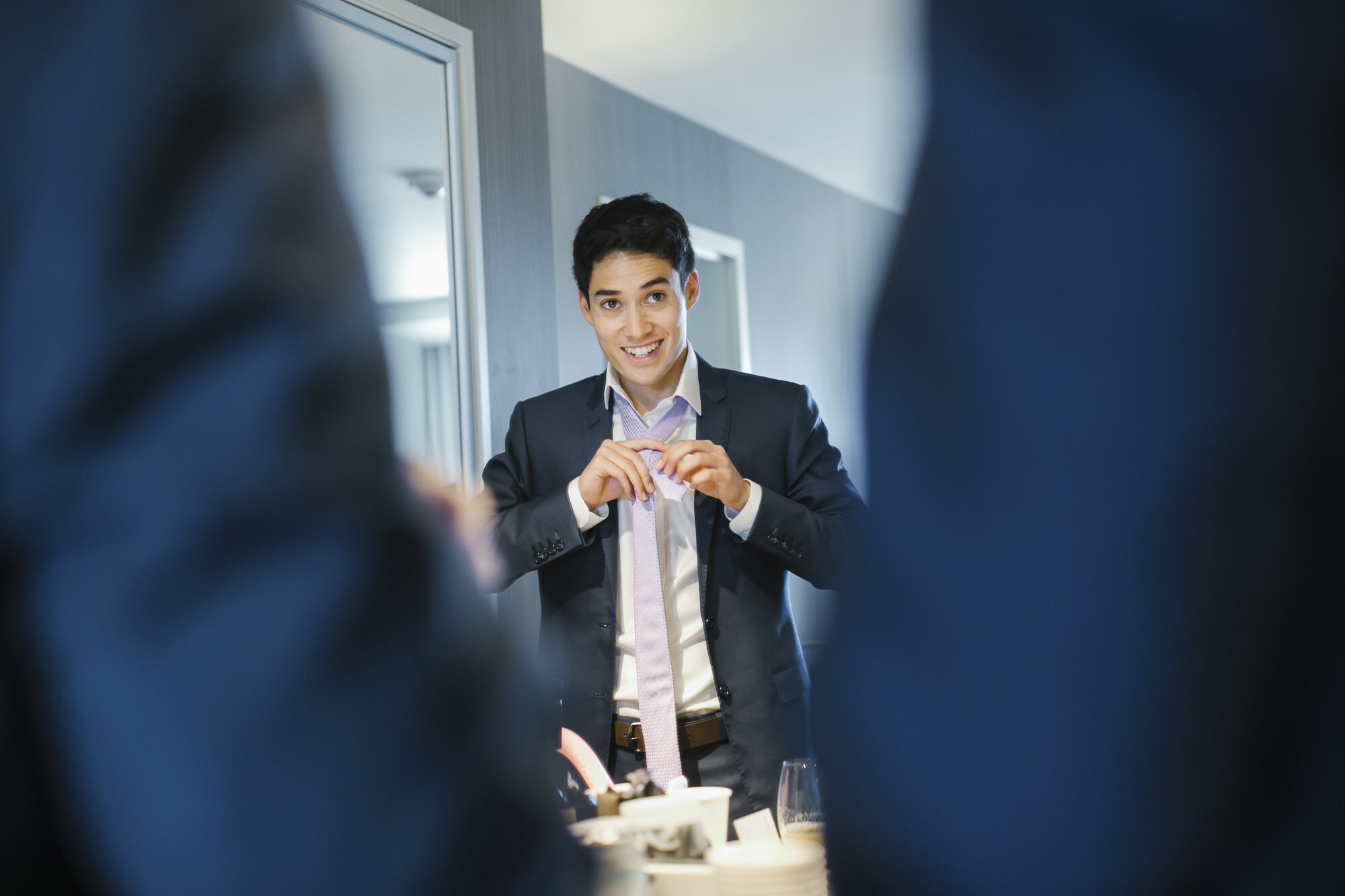 Groom in blue suit gets ready on his wedding day