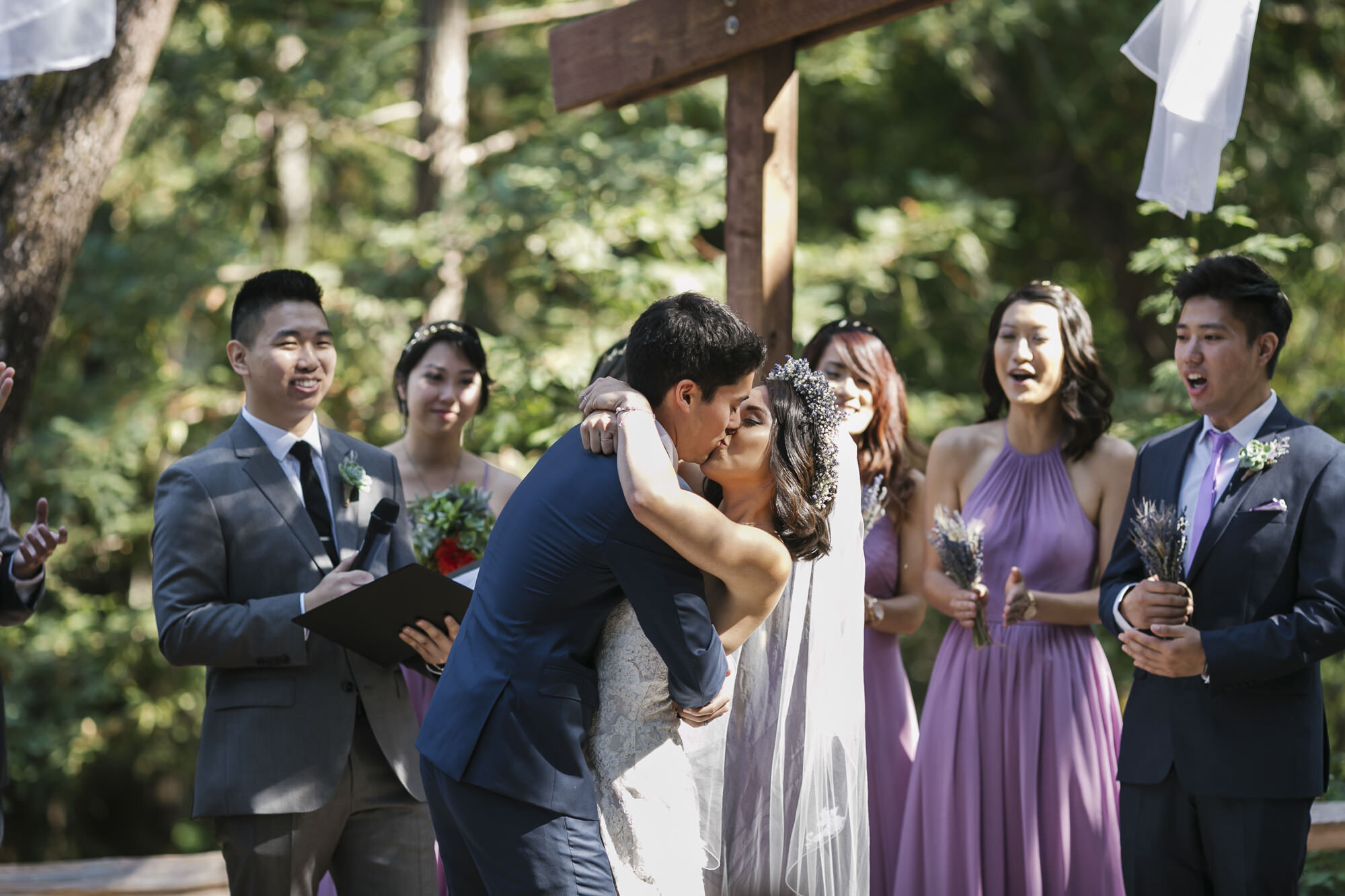 Bride and groom kiss at the end of their wedding ceremony