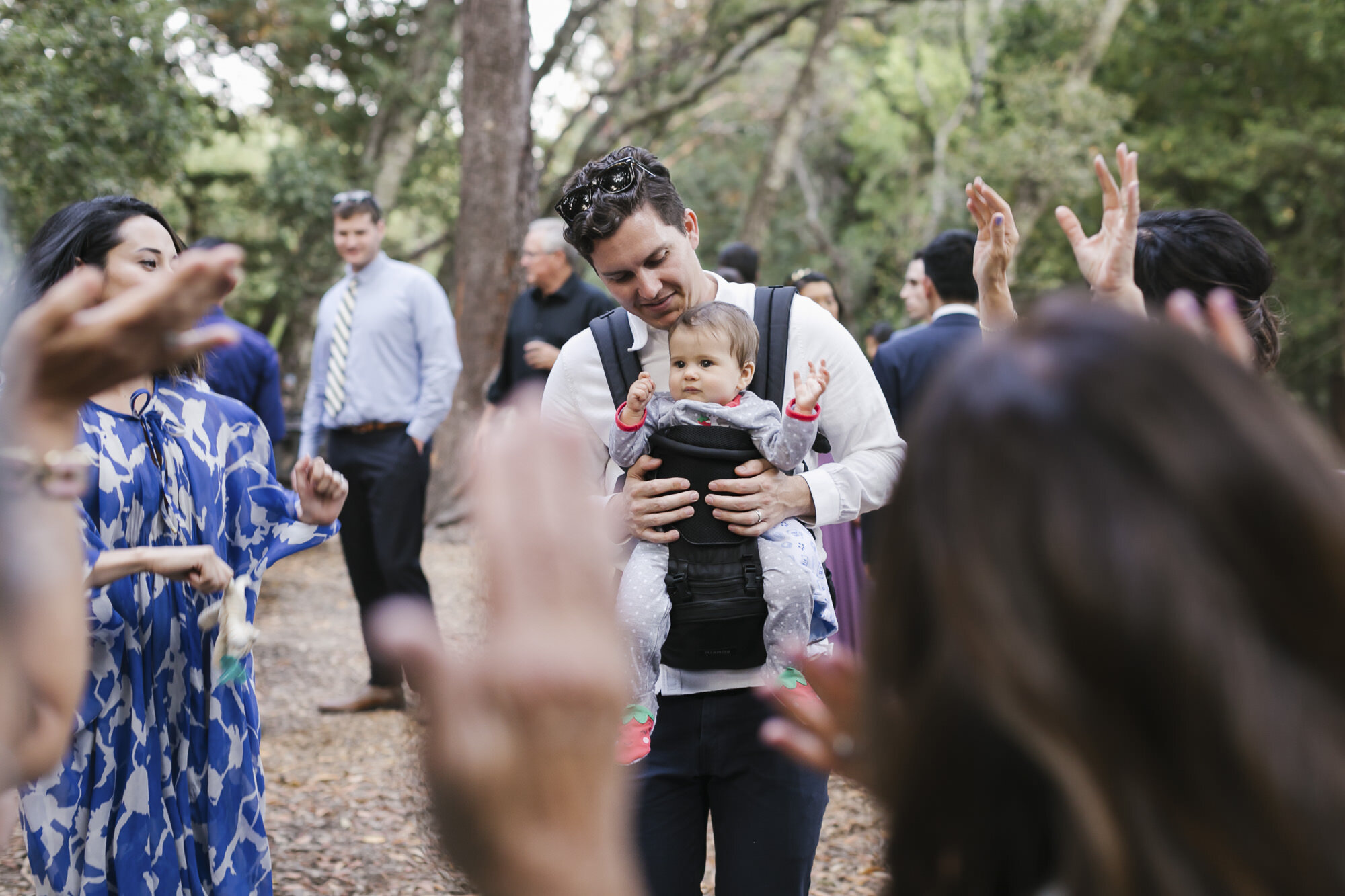 Baby enjoys dancing outdoors in a redwood forest