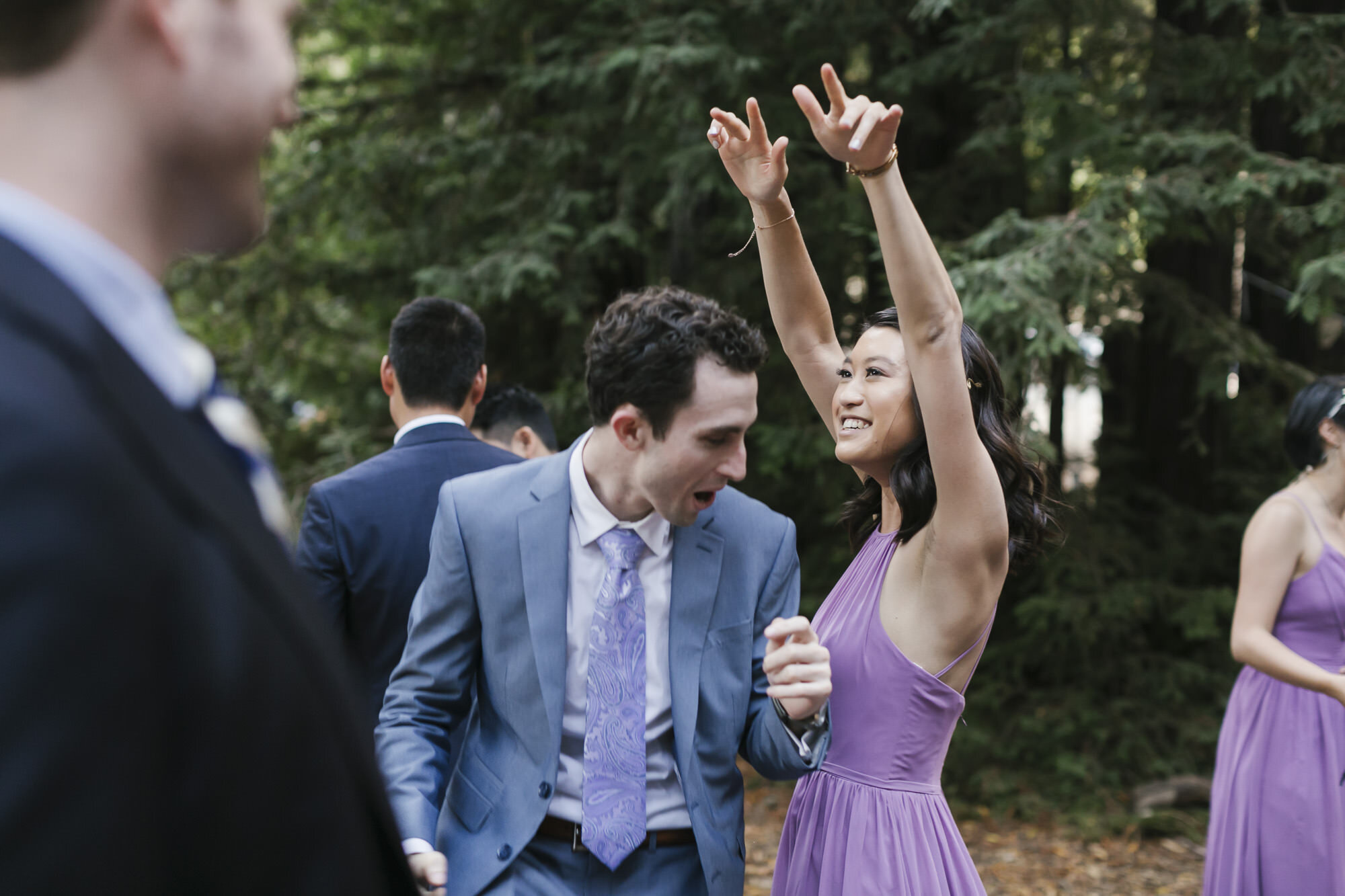 Guests enjoy dancing outdoors in a redwood forest