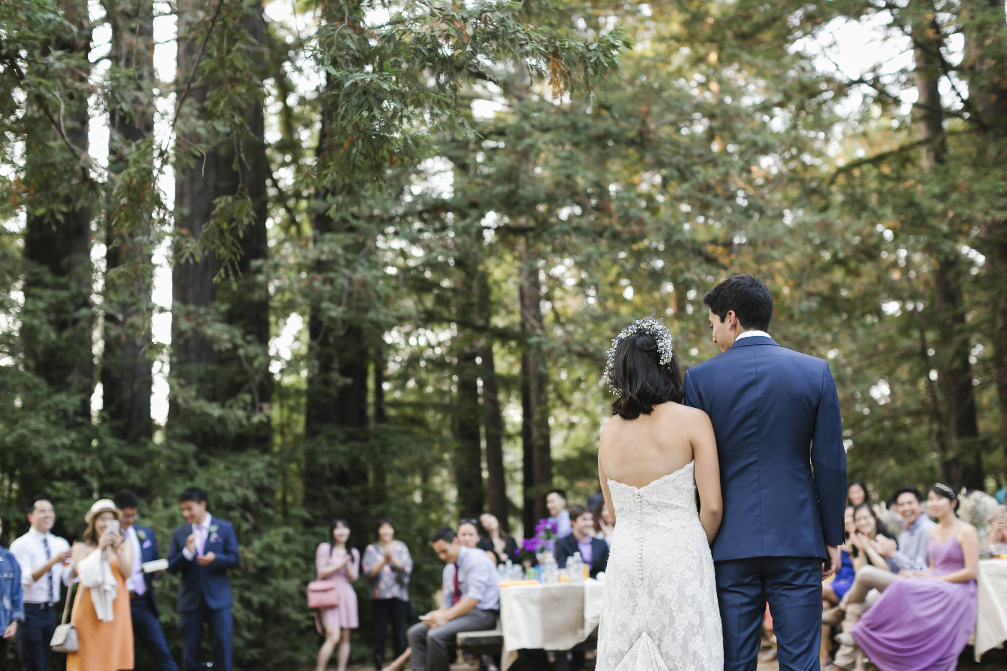 Bride and groom get ready for their first dance at outdoor reception