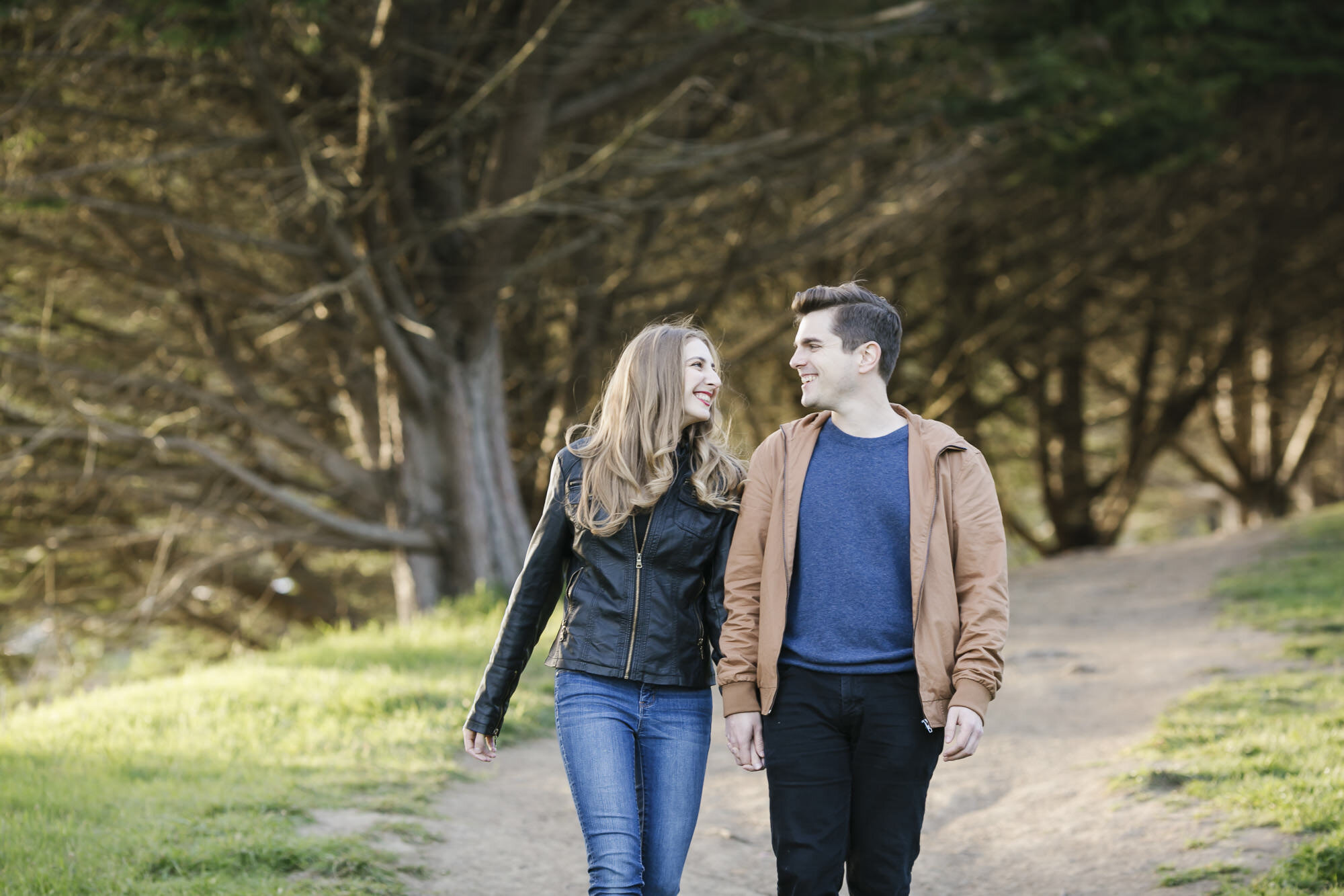 Engaged couple walk around Slide Ranch in Marin