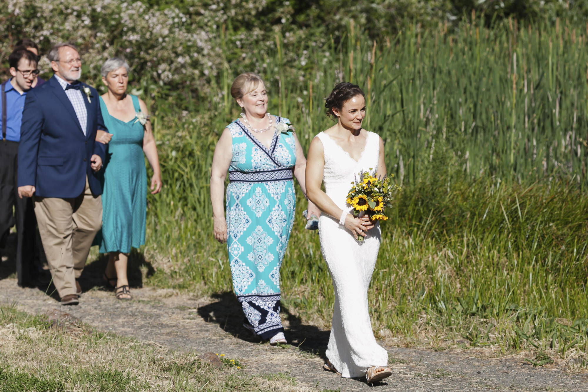 Bride leads guests into wedding ceremony in backyard Sonoma California