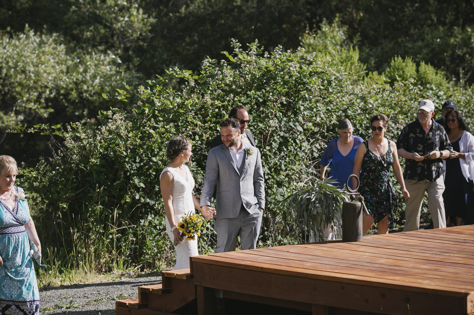 Bride and groom walk into wedding ceremony in backyard Sonoma California