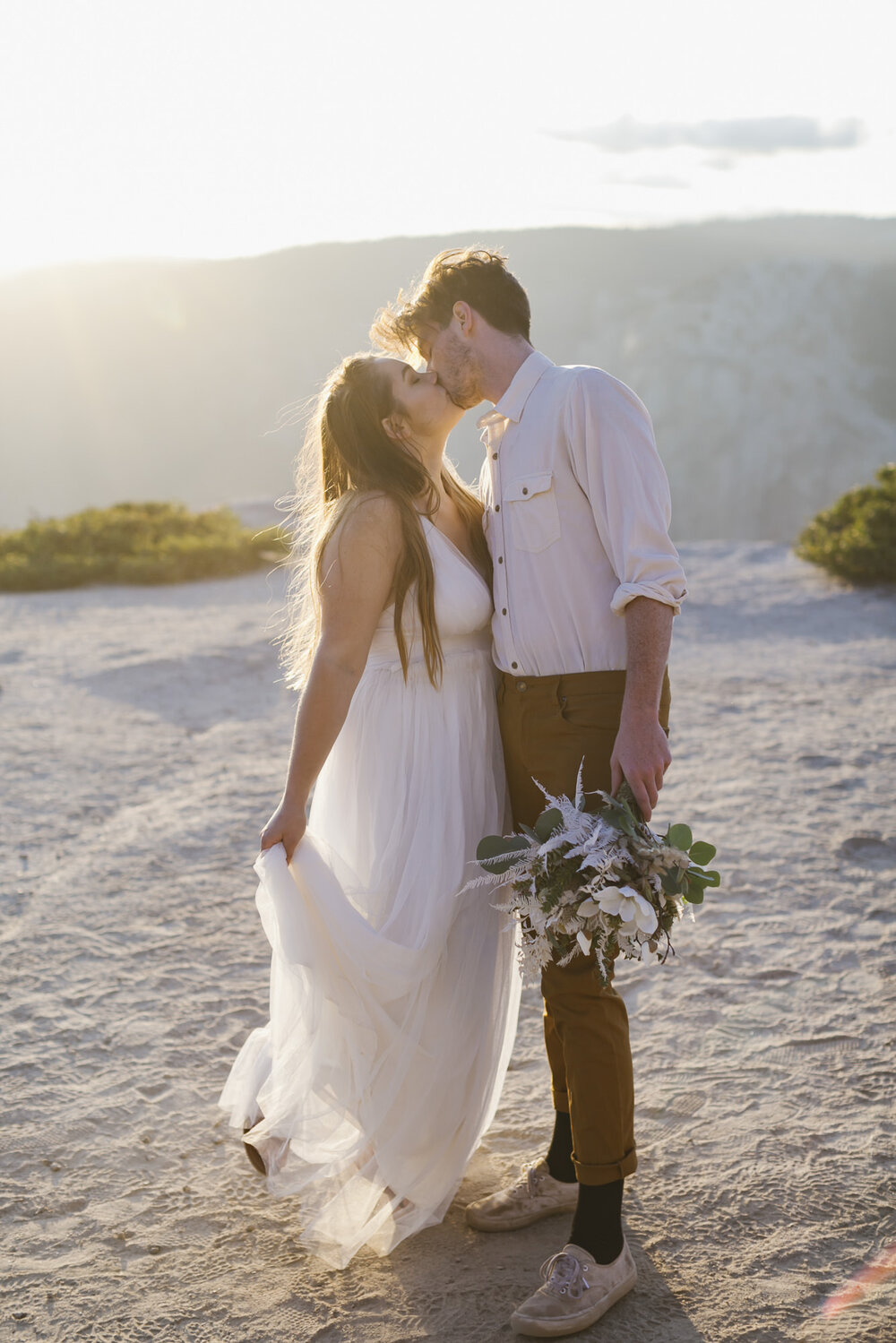 Wedding couple kiss at Taft Point during their elopement in Yosemite National Park