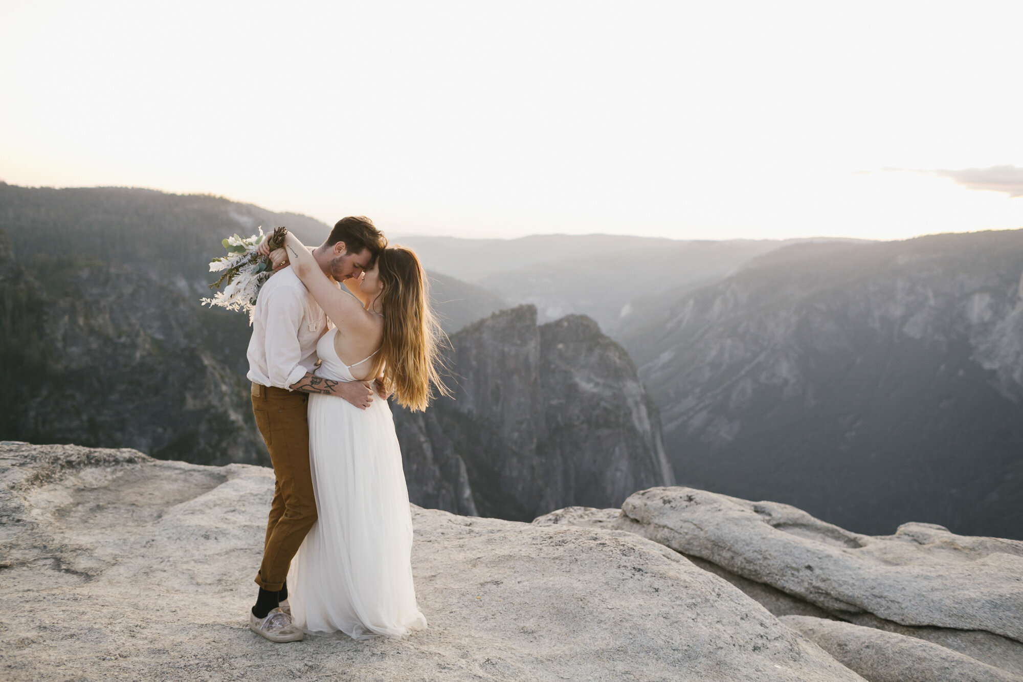 Wedding couple slow dance at Taft Point after exchanging vows during their Yosemite elopement