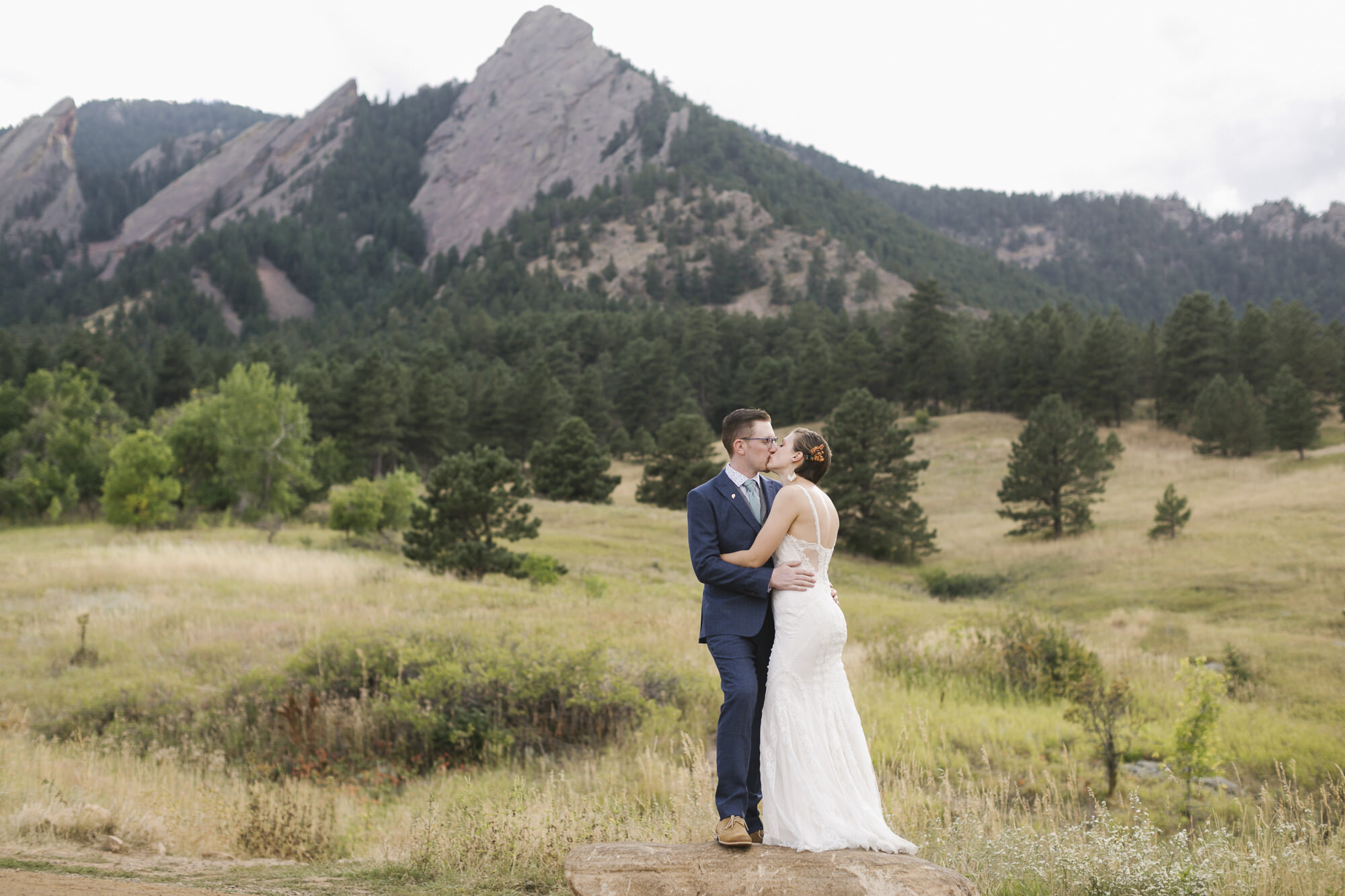 Wedding couple kiss in front of the Flatirons near Boulder Colorado