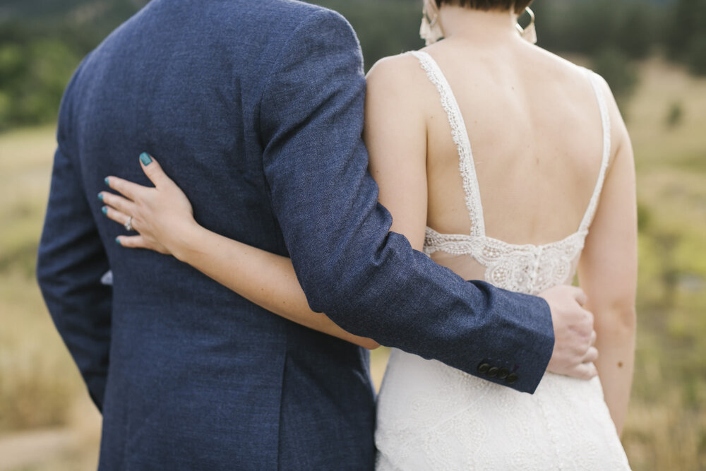 Close up of wedding couple's clothes and hands