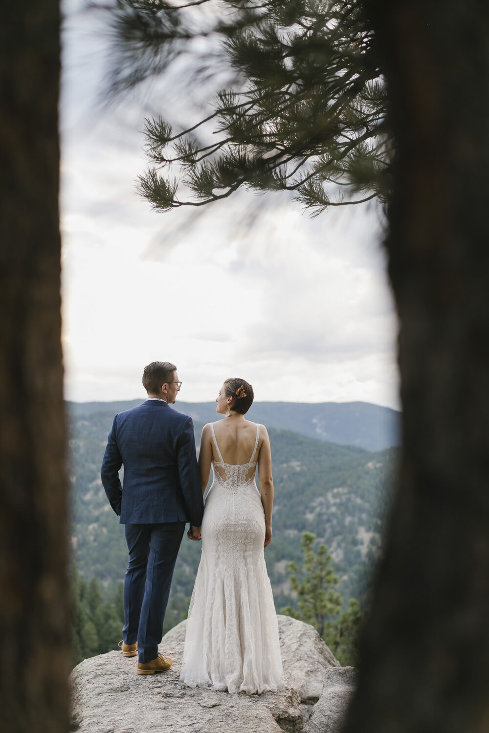 Adventure elopement couple look out at the view from Artist Point in Colorado