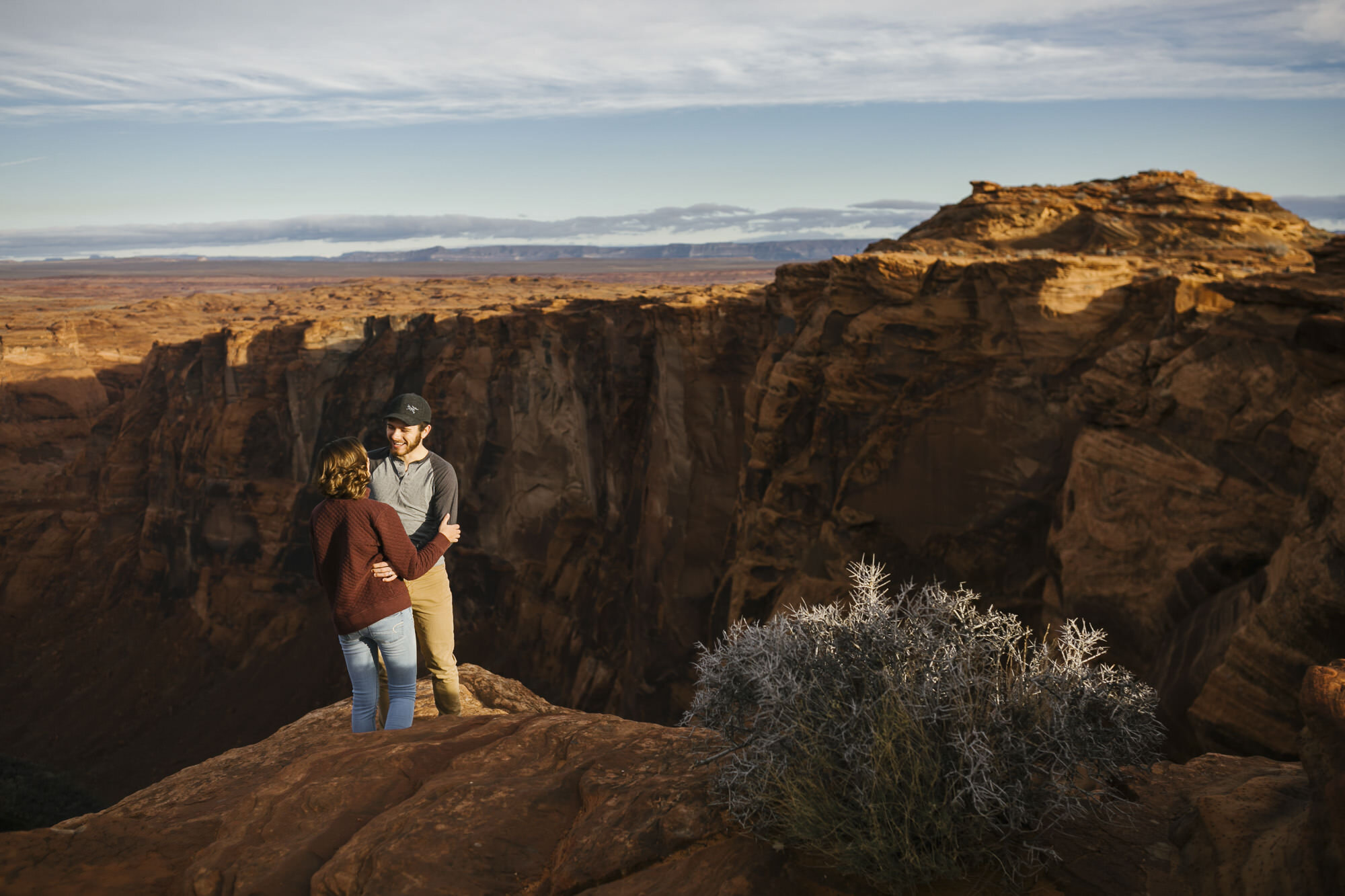 Adventurous couple take portraits at sunrise in the Arizona desert at Horseshoe Bend