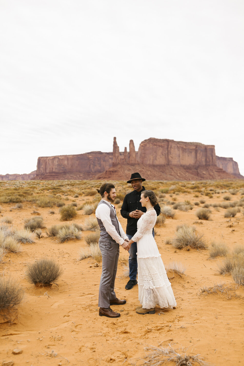 Couple exchange vows in the desert at their Monument Valley wedding