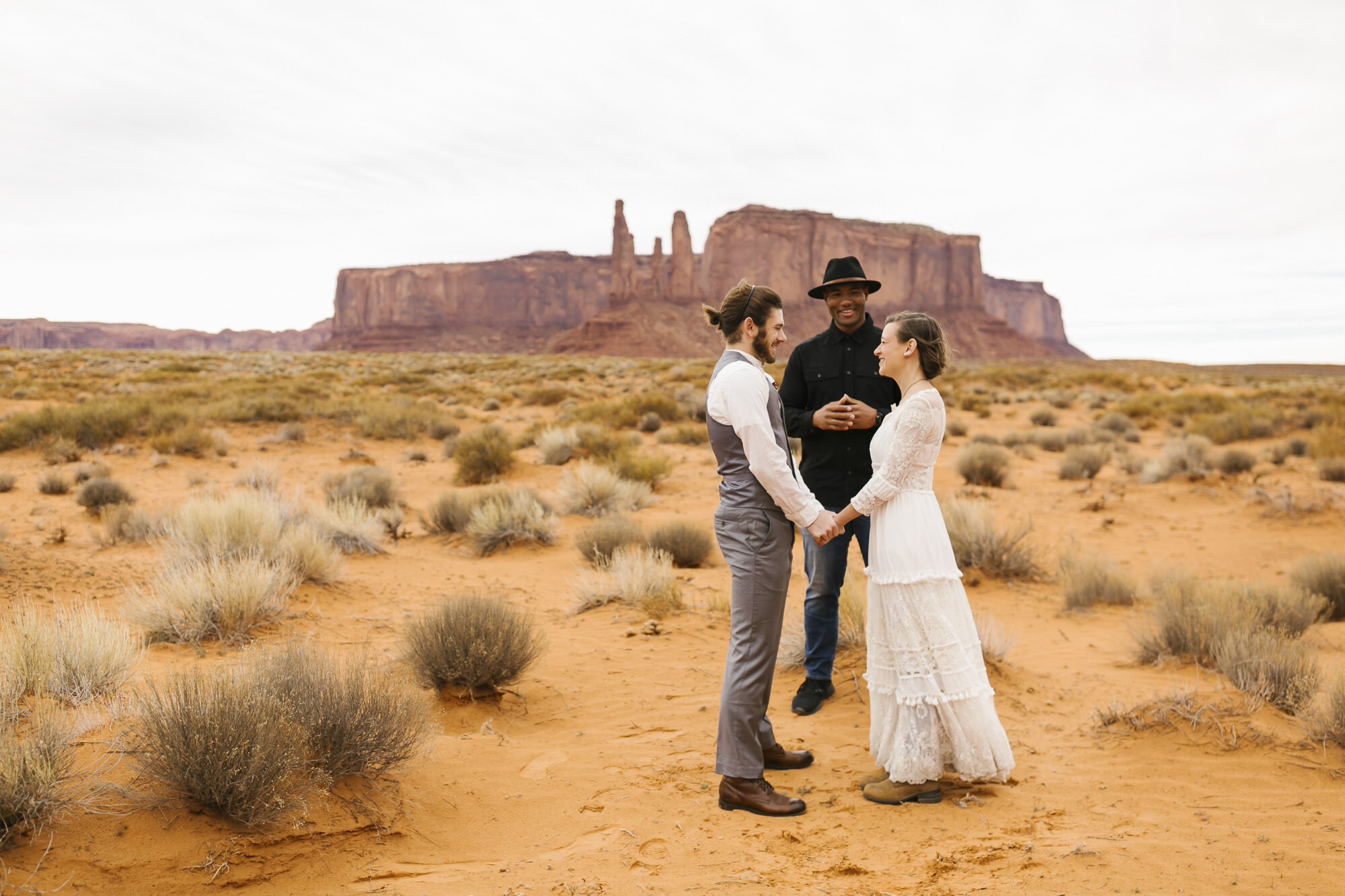 Bride and groom exchange vows in the desert at their Monument Valley wedding