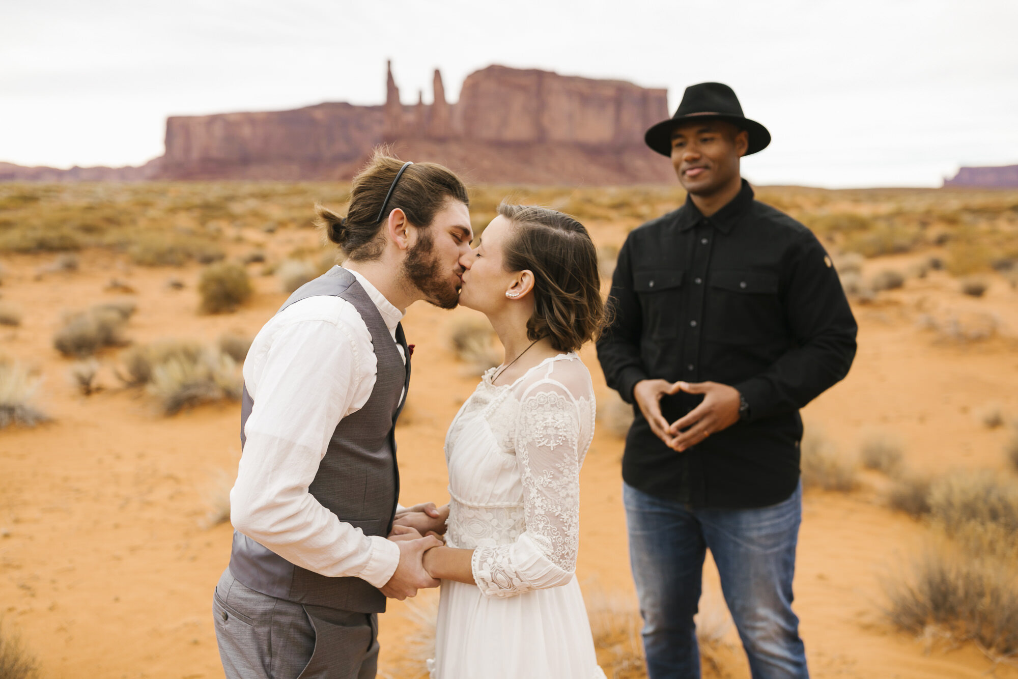 Just married couple share their first kiss after vow exchange at their Monument Valley wedding