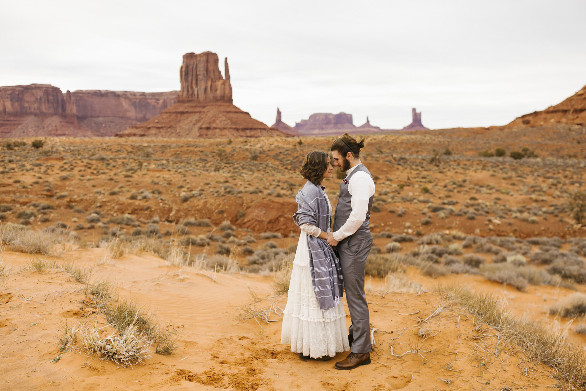 Bridge and groom snuggle after their Monument Valley wedding