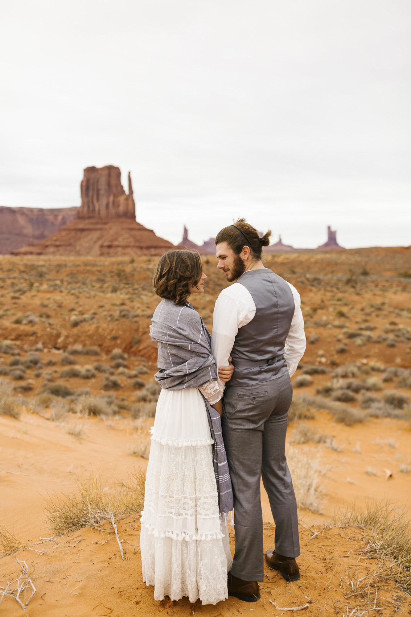 Wedding couple standing in front of the Mittens at Monument Valley in Arizona