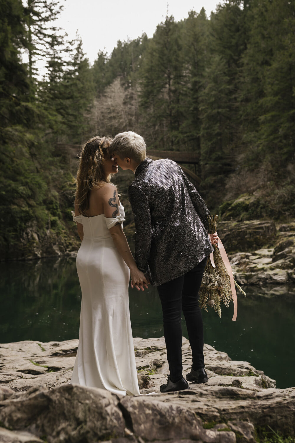 Wedding couple kiss on their elopement day in a forest in Washington