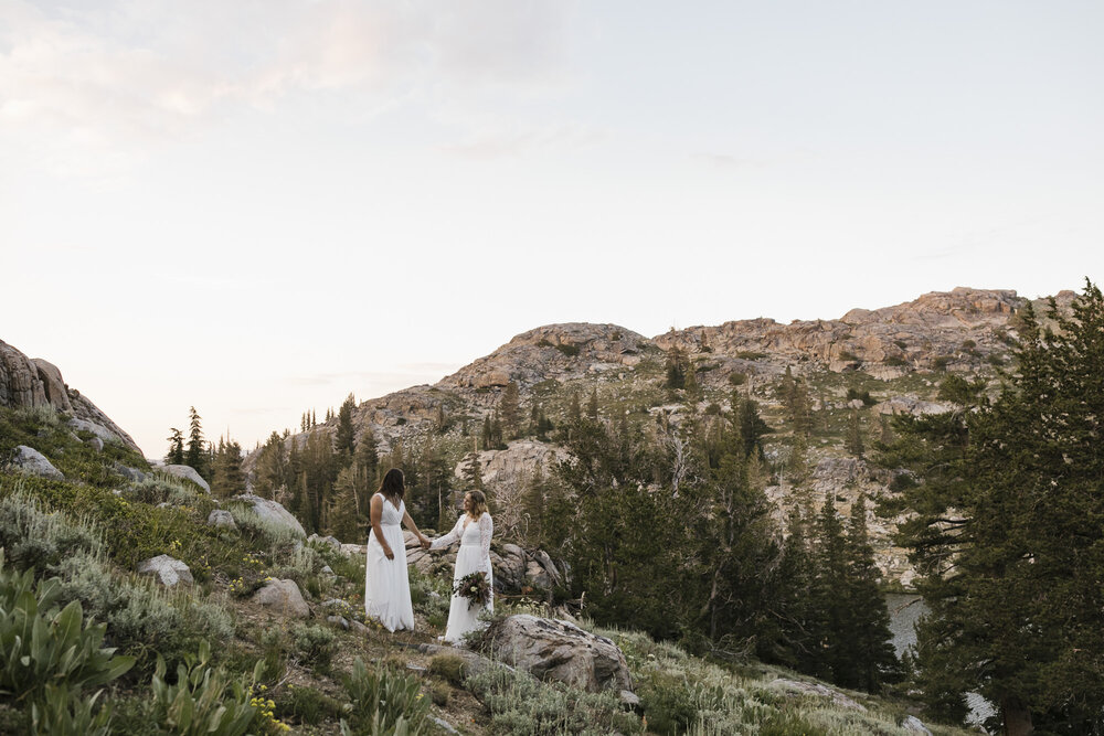 Wedding couple get ready to say their vows during their backpacking mountain elopement