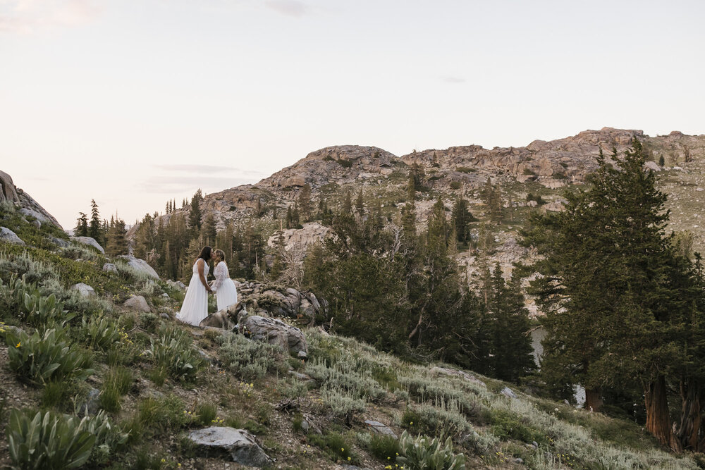 Just married couple kiss during their adventurous mountain elopement at sunset