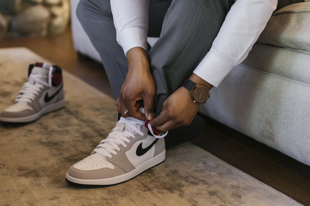 Groom puts on his Nike high top sneakers during his adventurous elopement