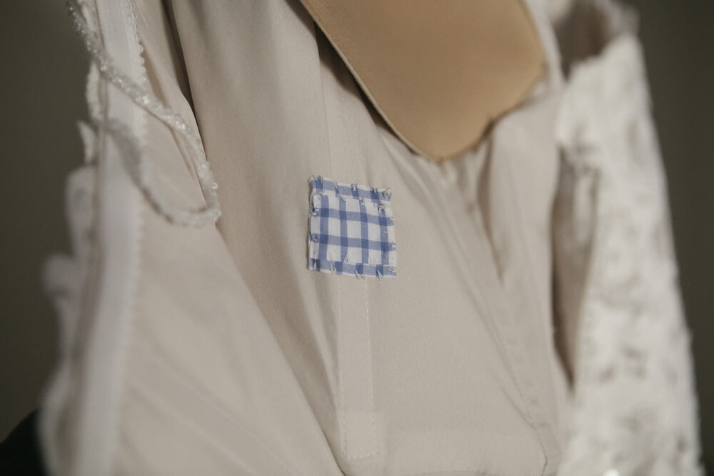 Small piece of bride's father's blue checkered shirt sewn into her wedding dress as a way to remember her dad