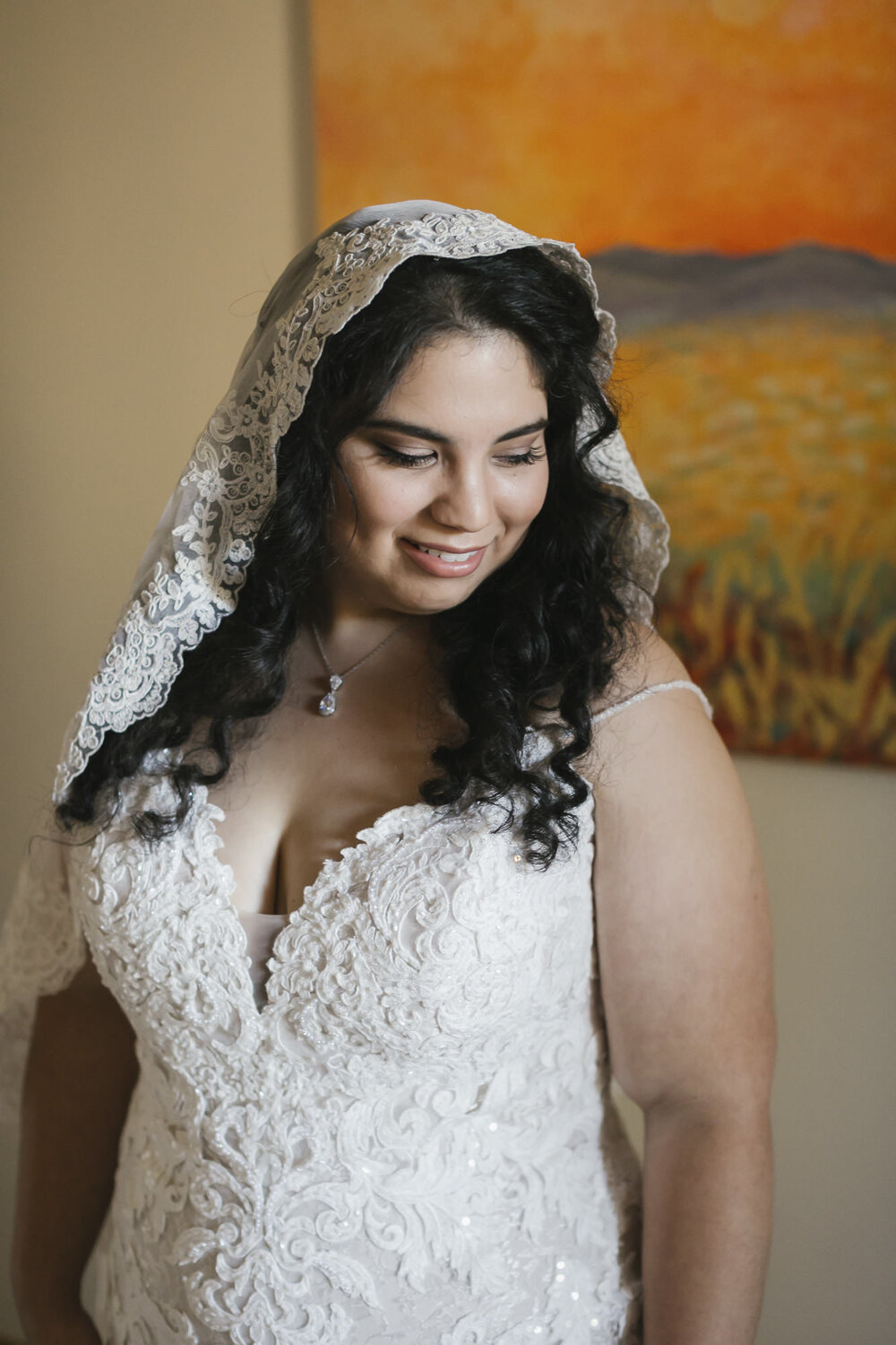 Bride after just putting on her wedding dress and handmade veil for the first time during her forest elopement