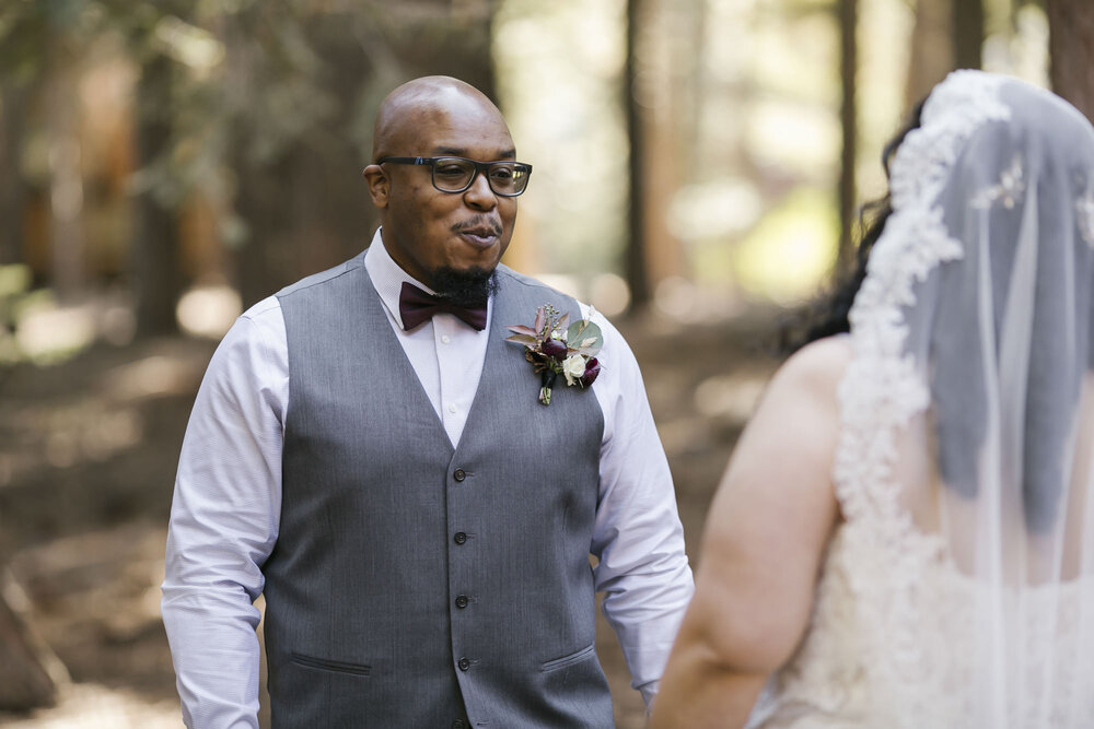 Groom reacts joyfully when seeing his bride for the first time during their forest elopement in Tahoe California