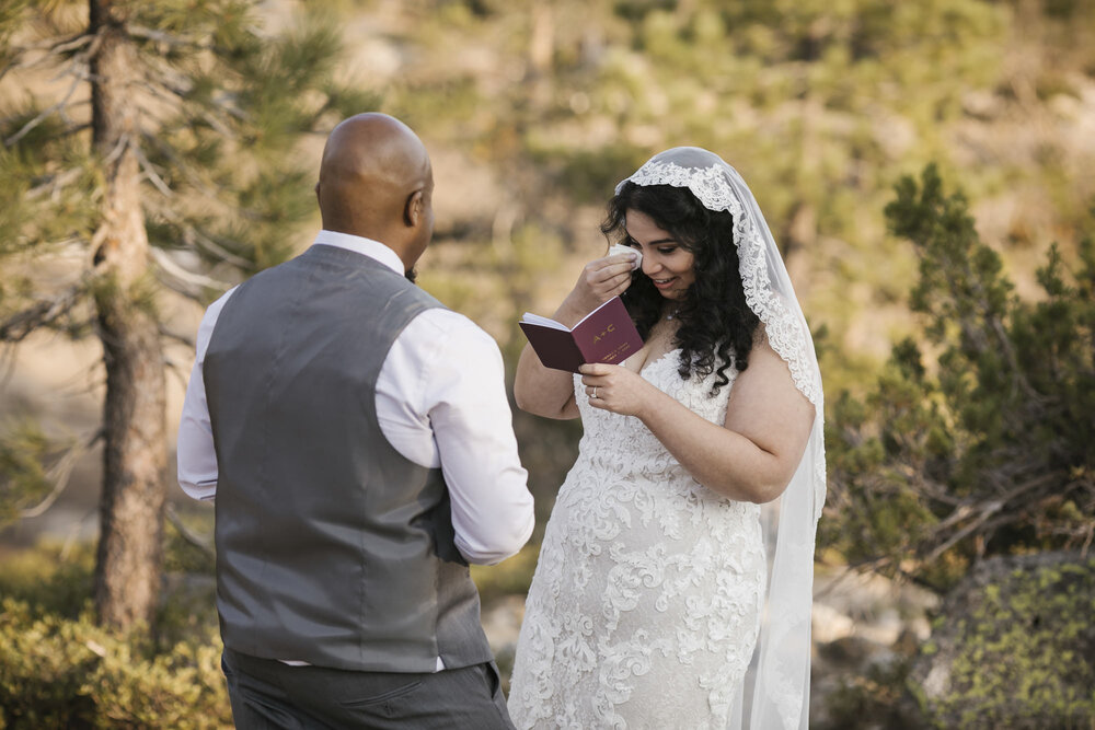 Bride wipes her tears during her vow exchange in the Tahoe forest