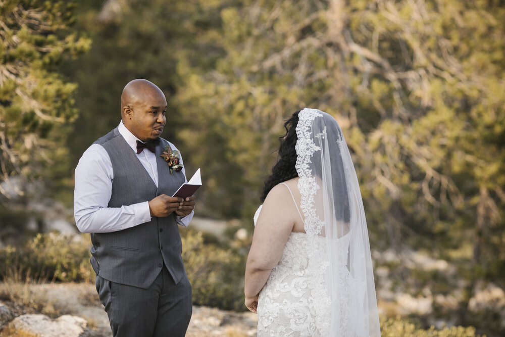 Groom reads his vows to his bride during their Tahoe forest elopement