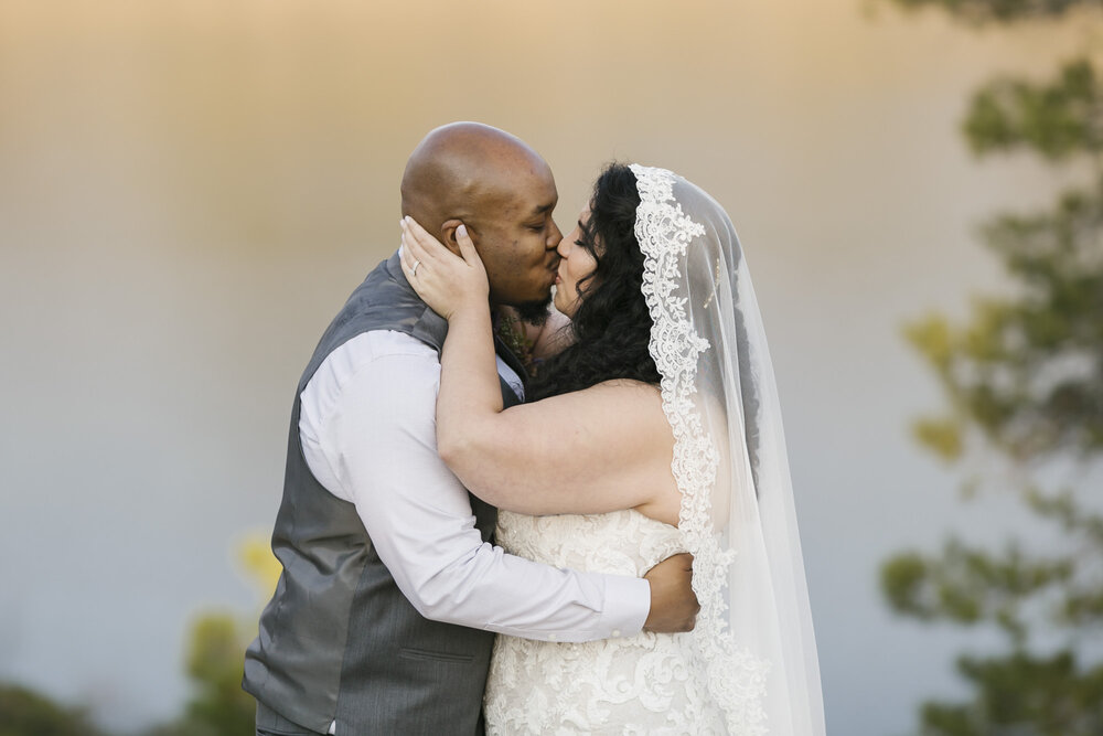 Bride and groom celebrate just getting married with a kiss