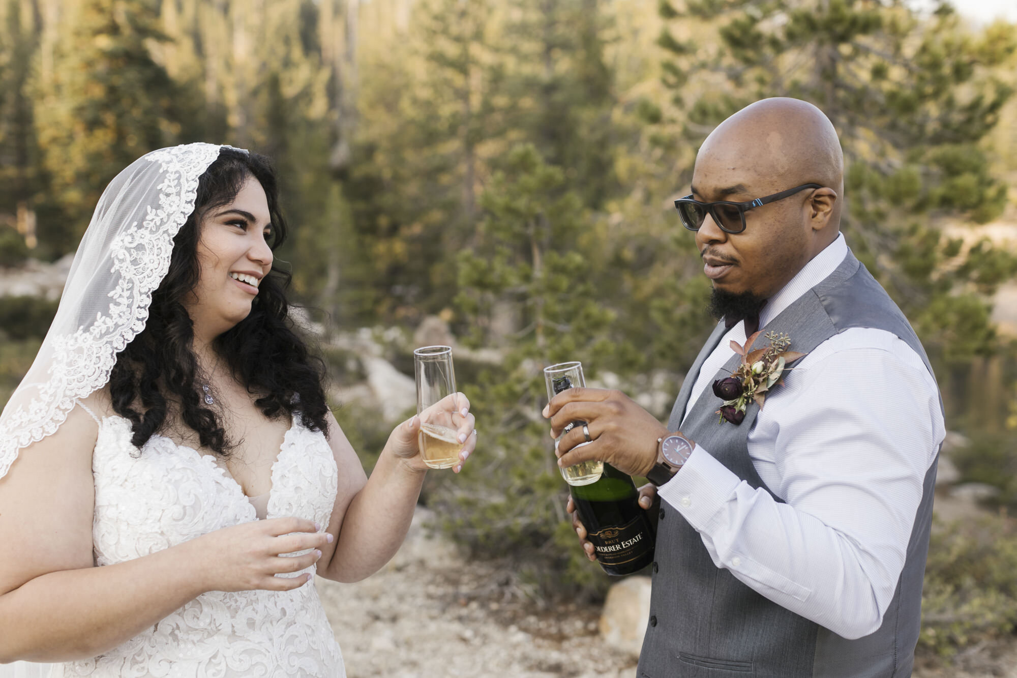 Just married couple toast champagne in the Tahoe forest