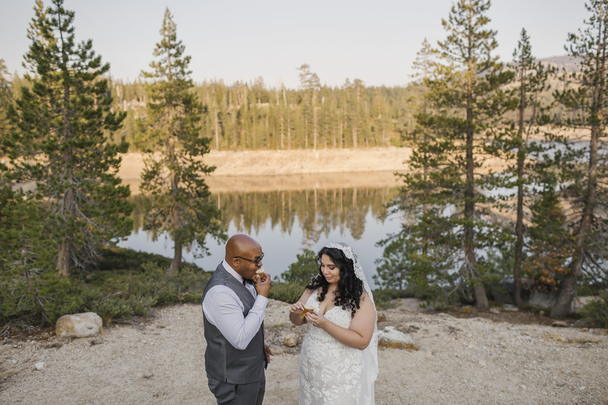 Bride and groom enjoy champagne and cupcakes after their wedding ceremony in the forest