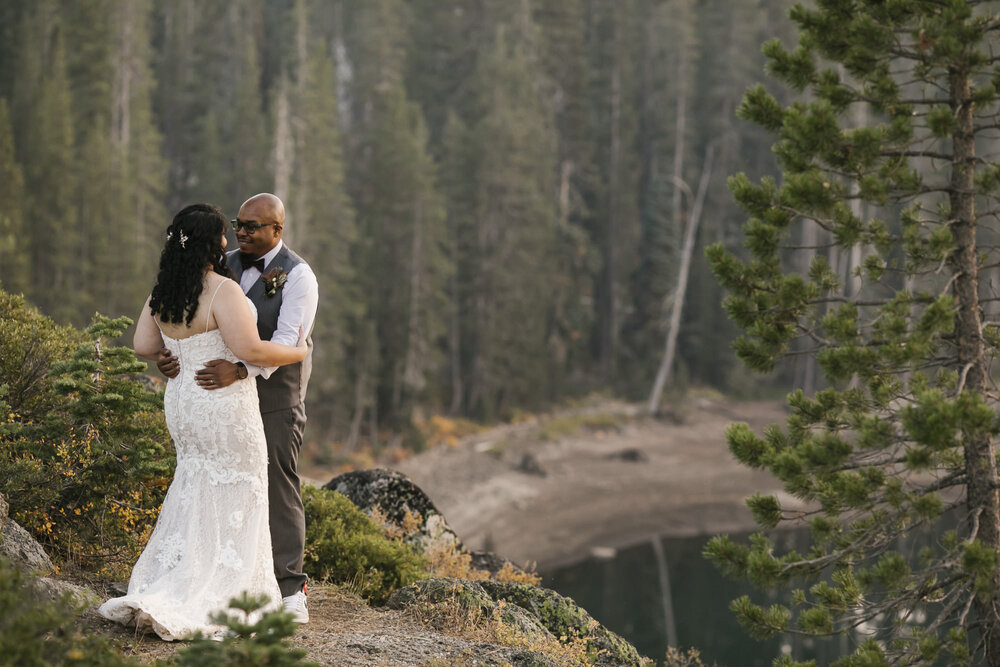 Bride and groom hold each other close in Tahoe forest