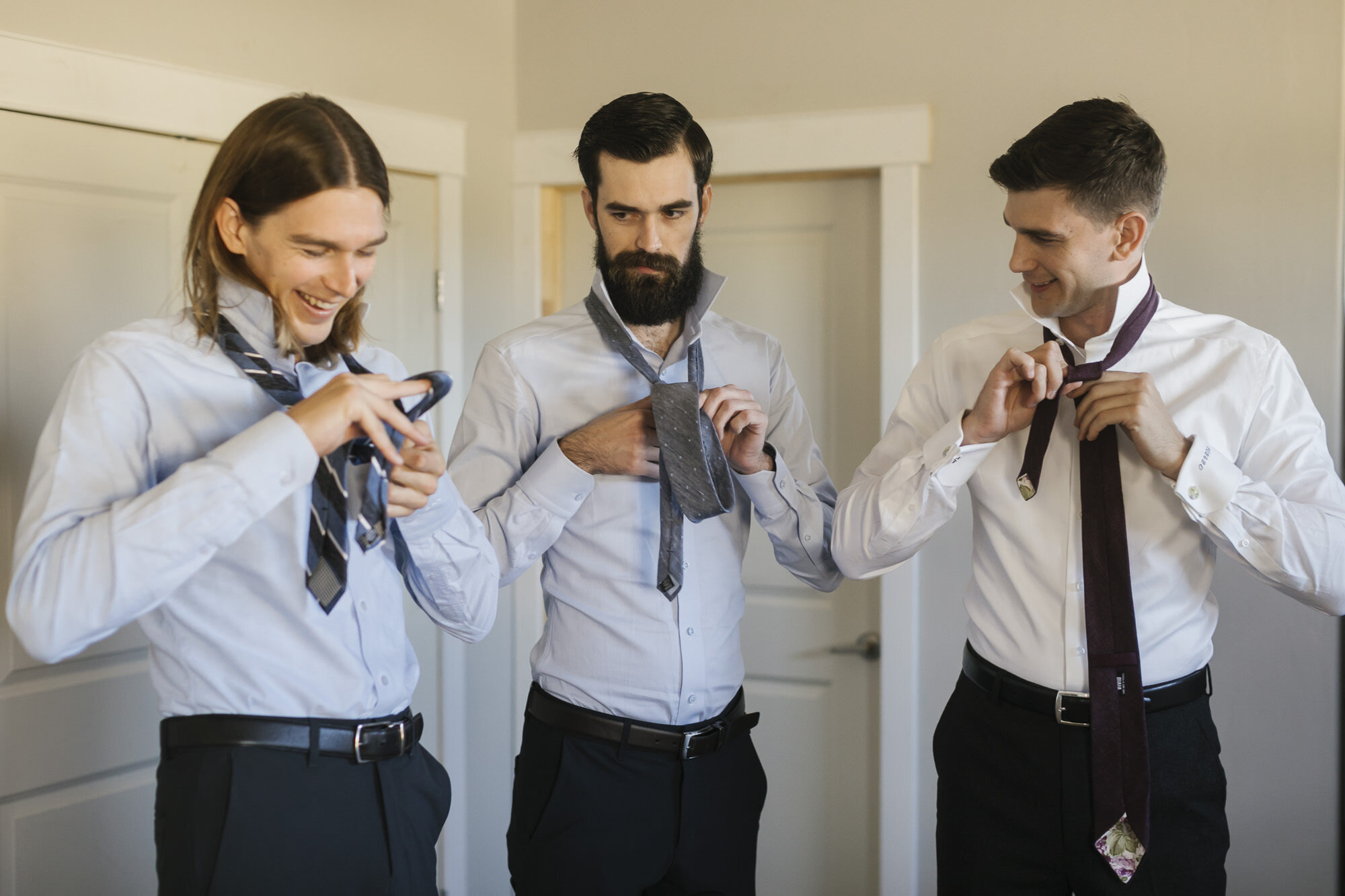 Groom and his brothers tie their ties together