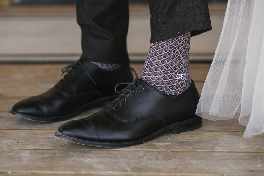 Close up detail of the groom's custom monogrammed socks