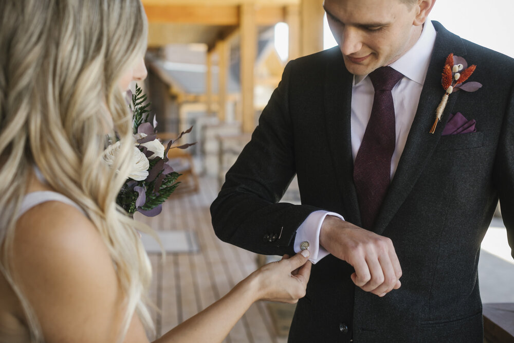 Bride admires her groom's custom map cufflinks