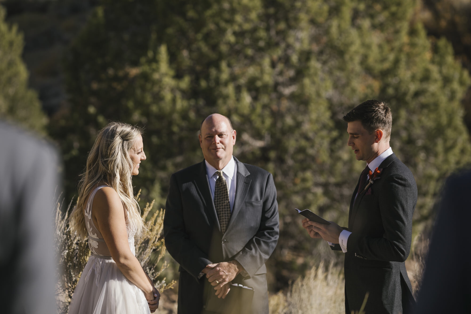 Bride and groom exchange vows during their Utah desert wedding