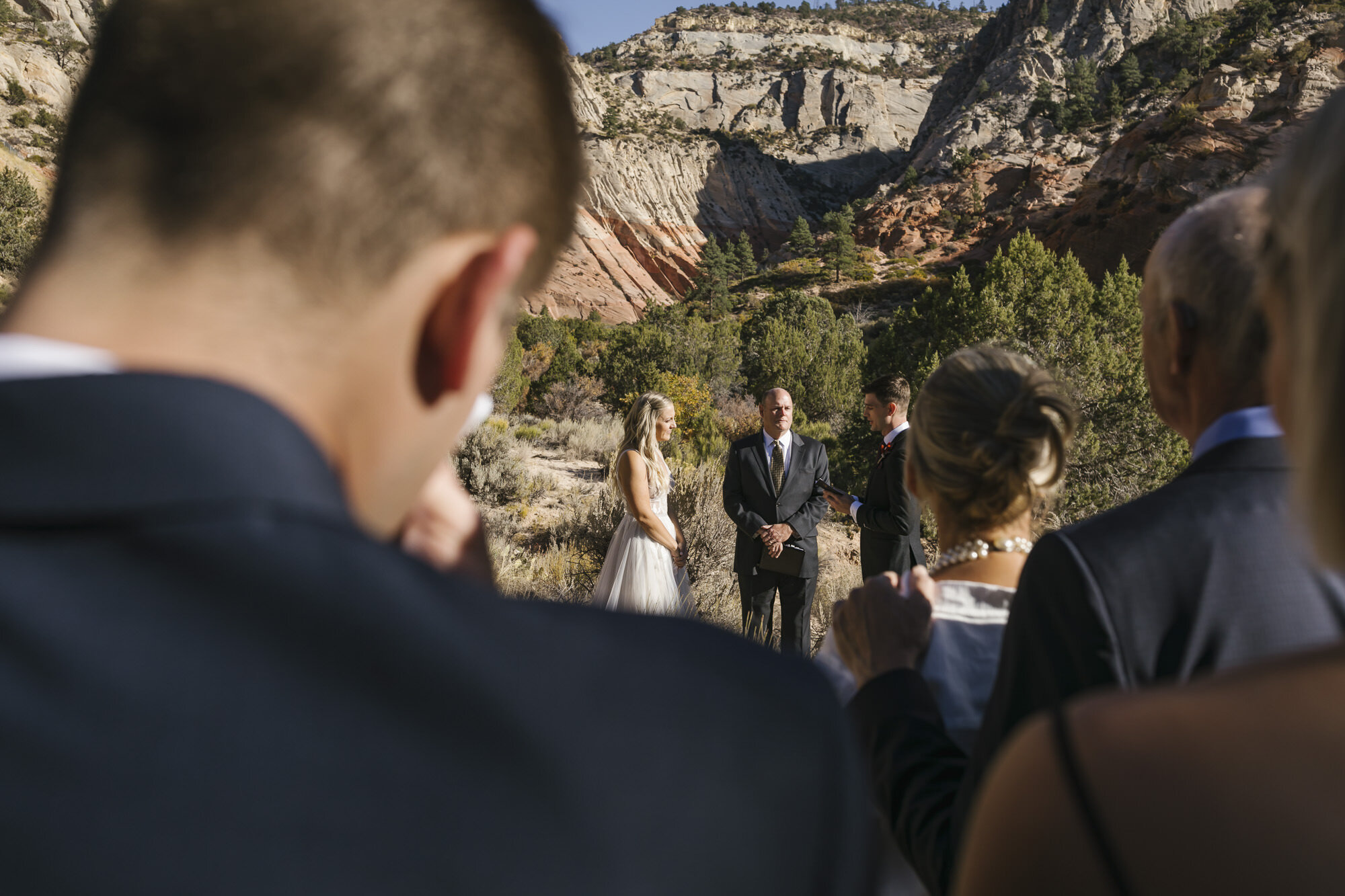 Immediate family stand together witnessing a Utah desert wedding