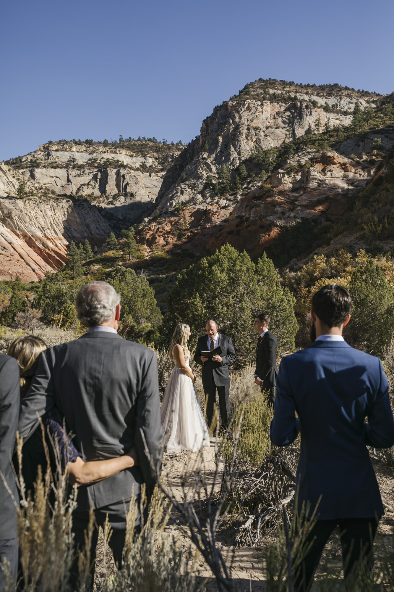 Bride and groom exchange vows during their micro wedding in the Utah desert