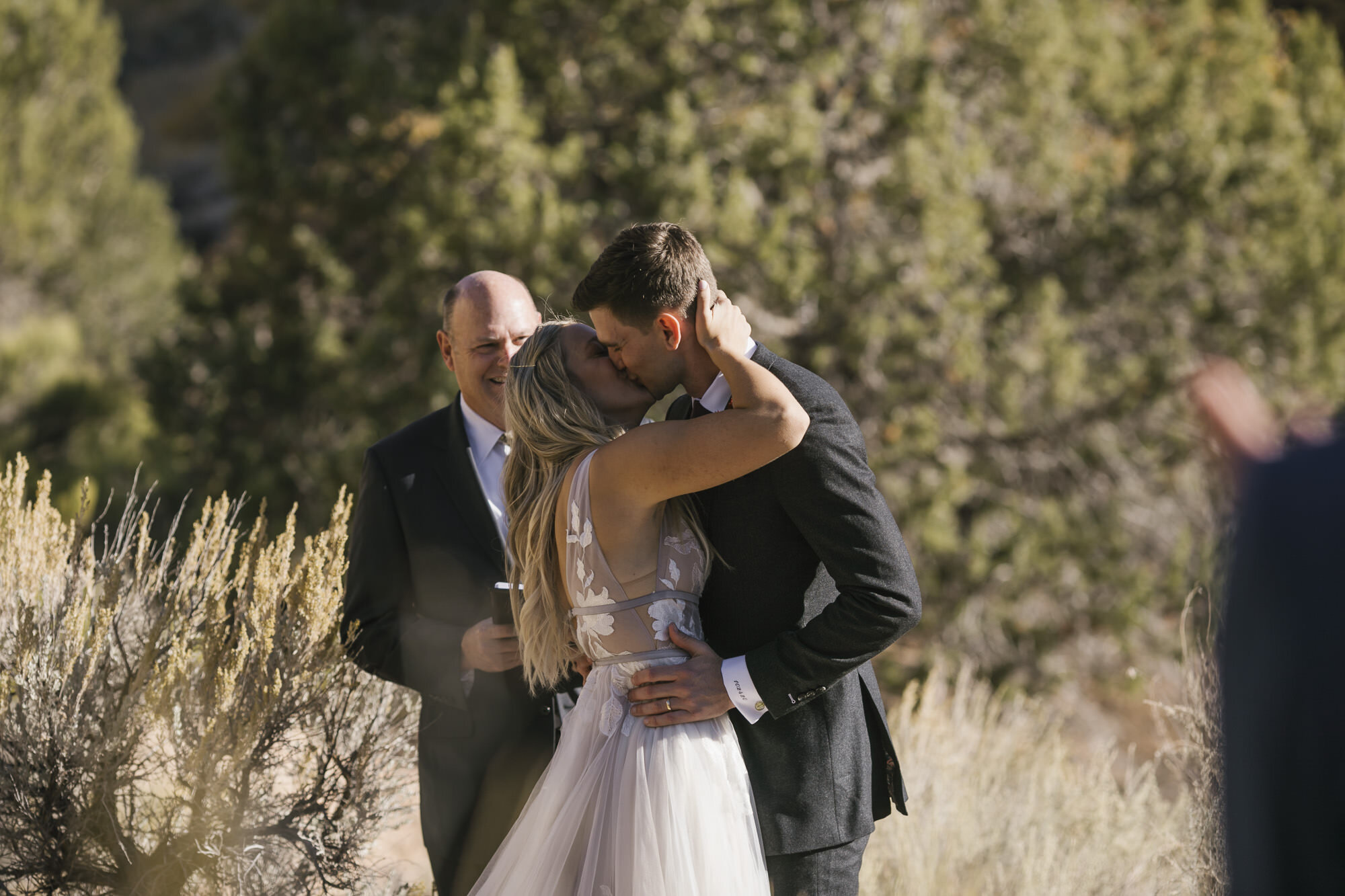 Bride and groom share their first kiss after getting married in the Utah desert